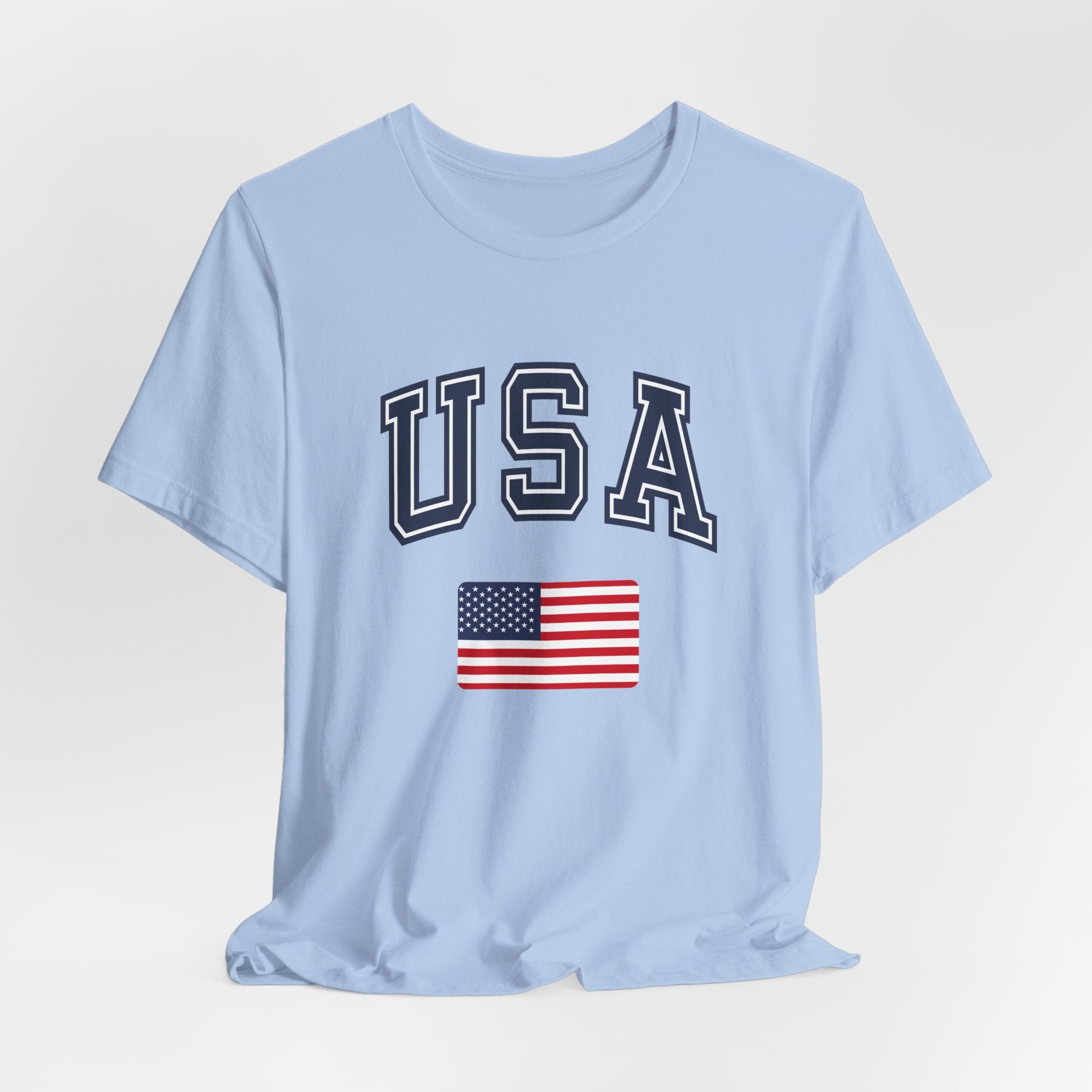 Light blue t-shirt with 'USA' text and American flag on a light gray background
