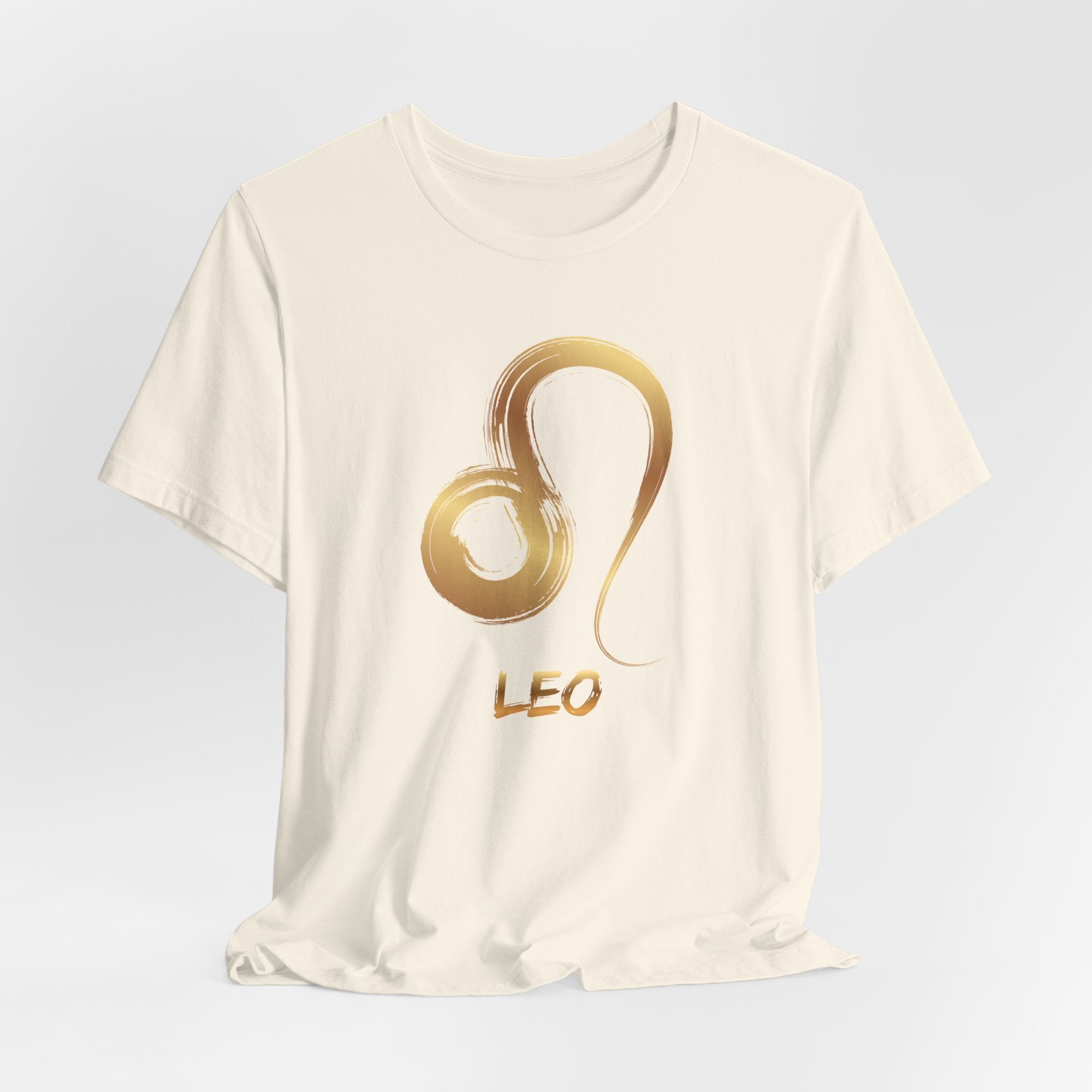 White t-shirt with gold Leo zodiac symbol on a light gray background