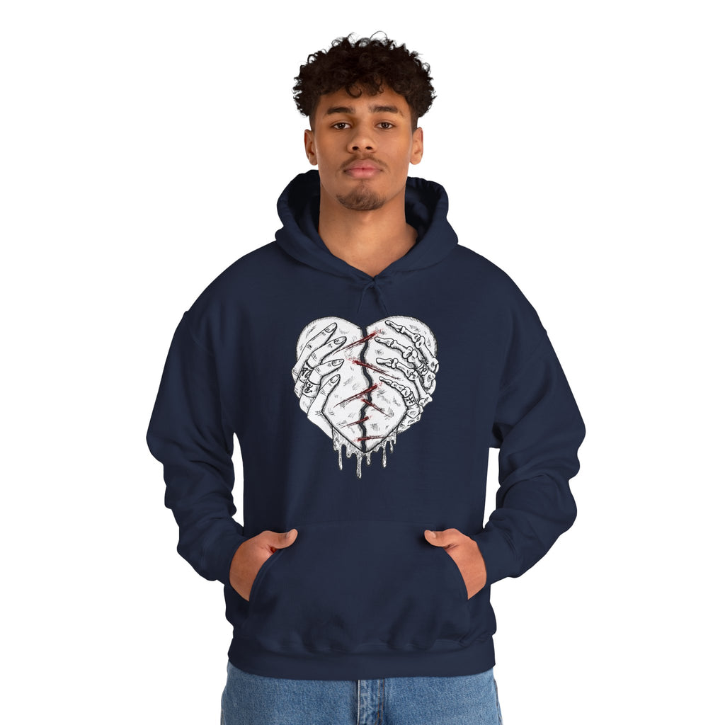 Person wearing a navy hoodie with a heart design on a white background