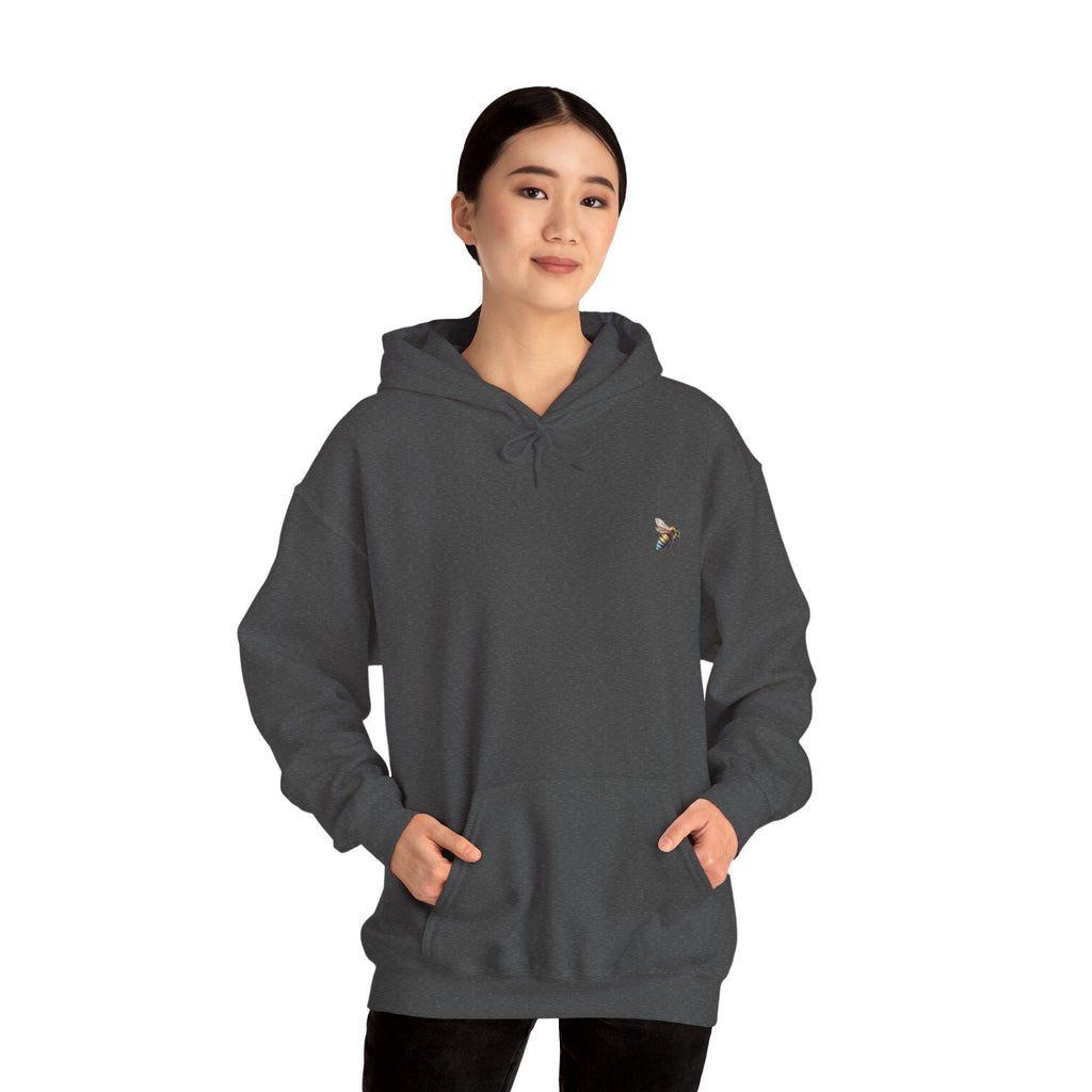 Person wearing a dark gray hoodie with a logo on a white background