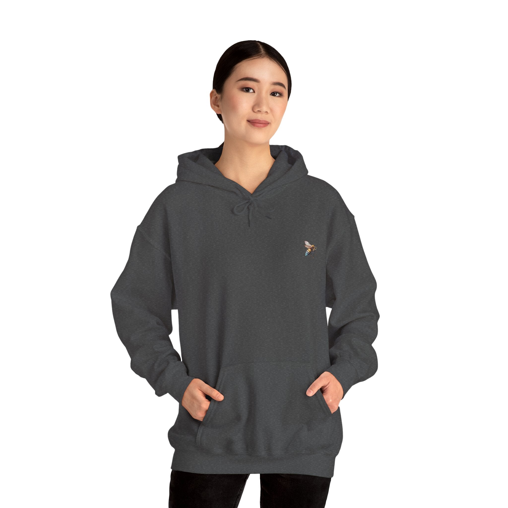 Person wearing a dark gray hoodie with a logo on a white background