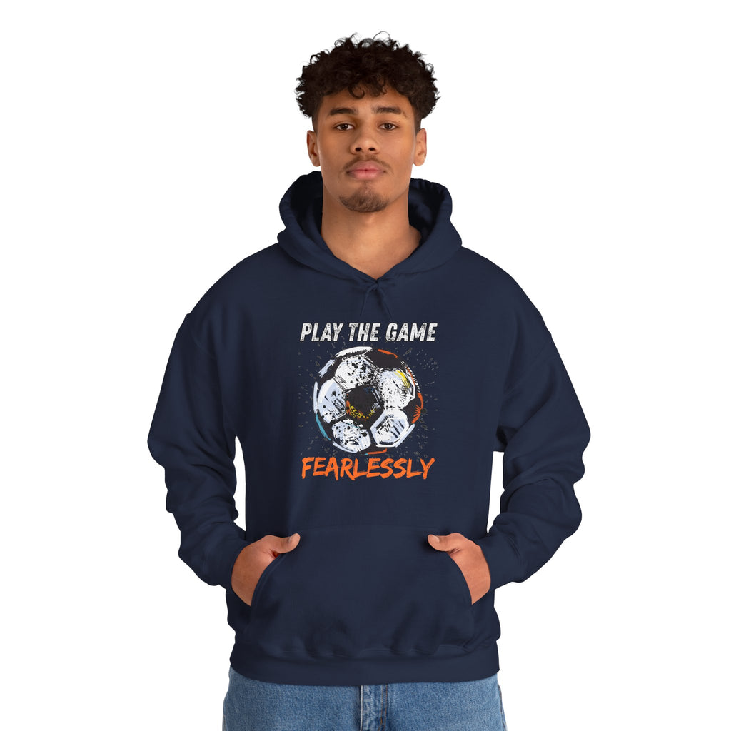 A man wearing navy blue hoodie with dirty soccer ball graphic and play the game fearlessly text on a white background