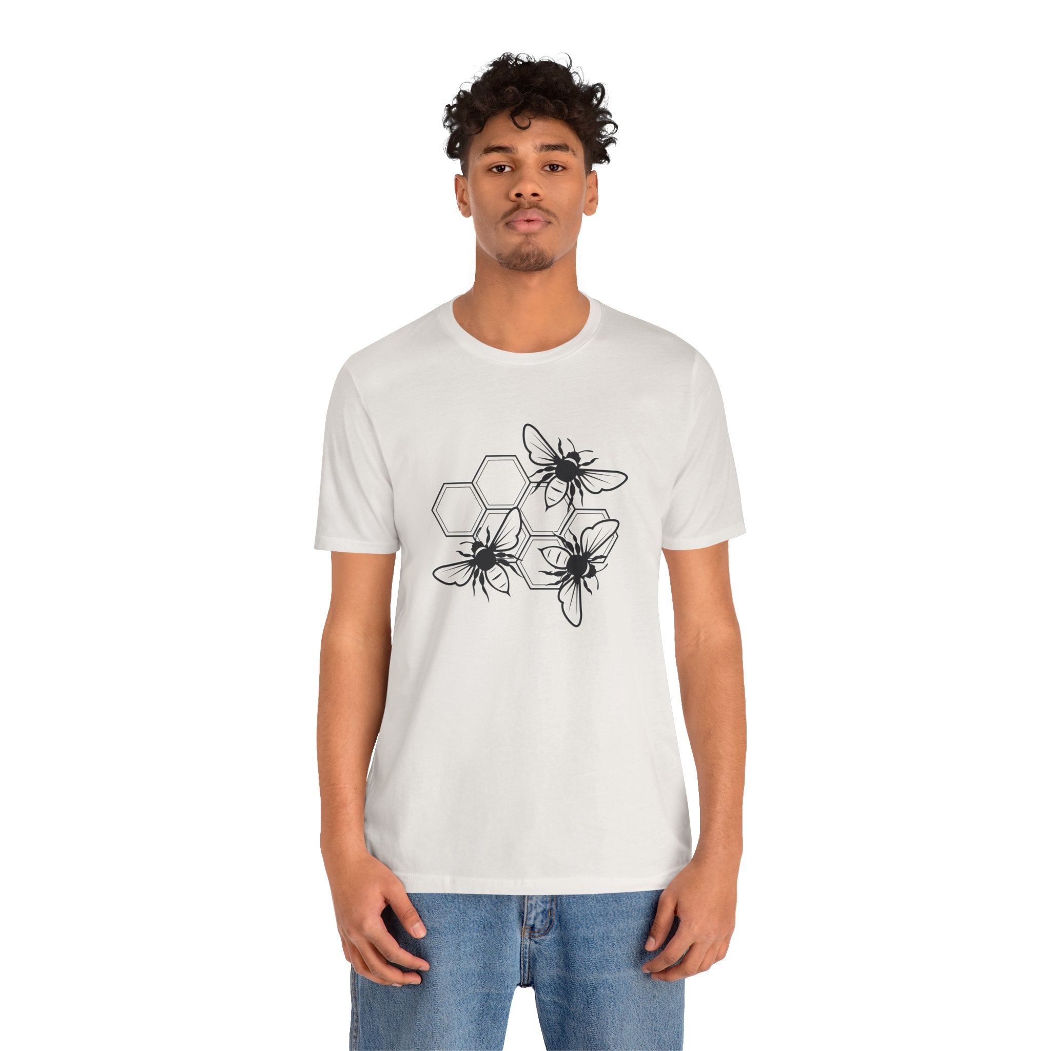 Person wearing a white t-shirt with black spider design on a white background