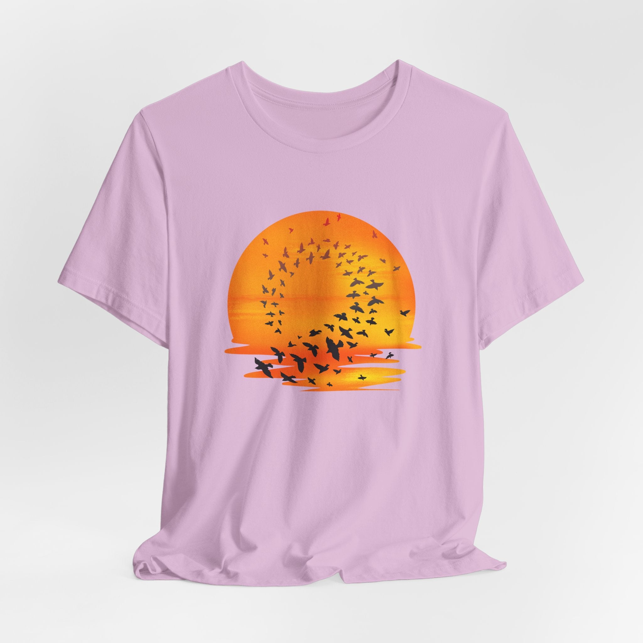 Purple t-shirt with a sunset and bird design on a light gray background