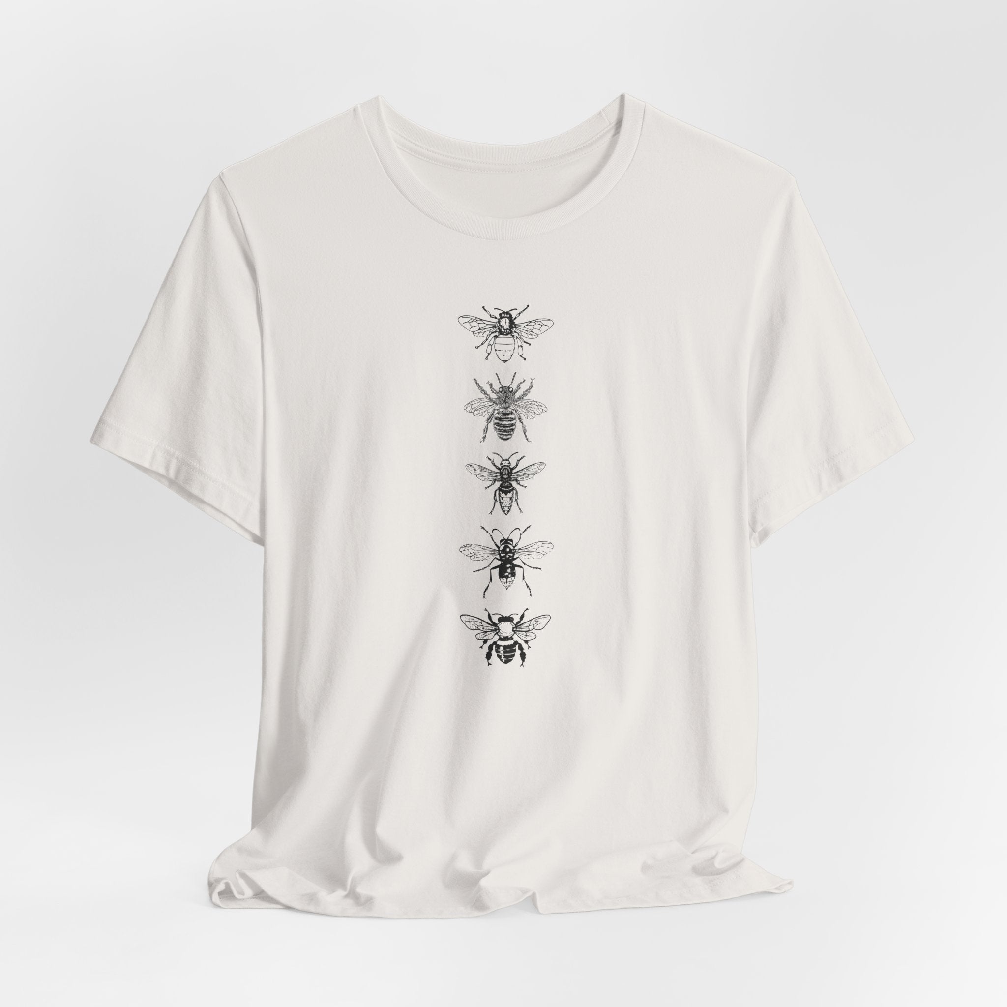 White t-shirt with black bee illustrations on a white background