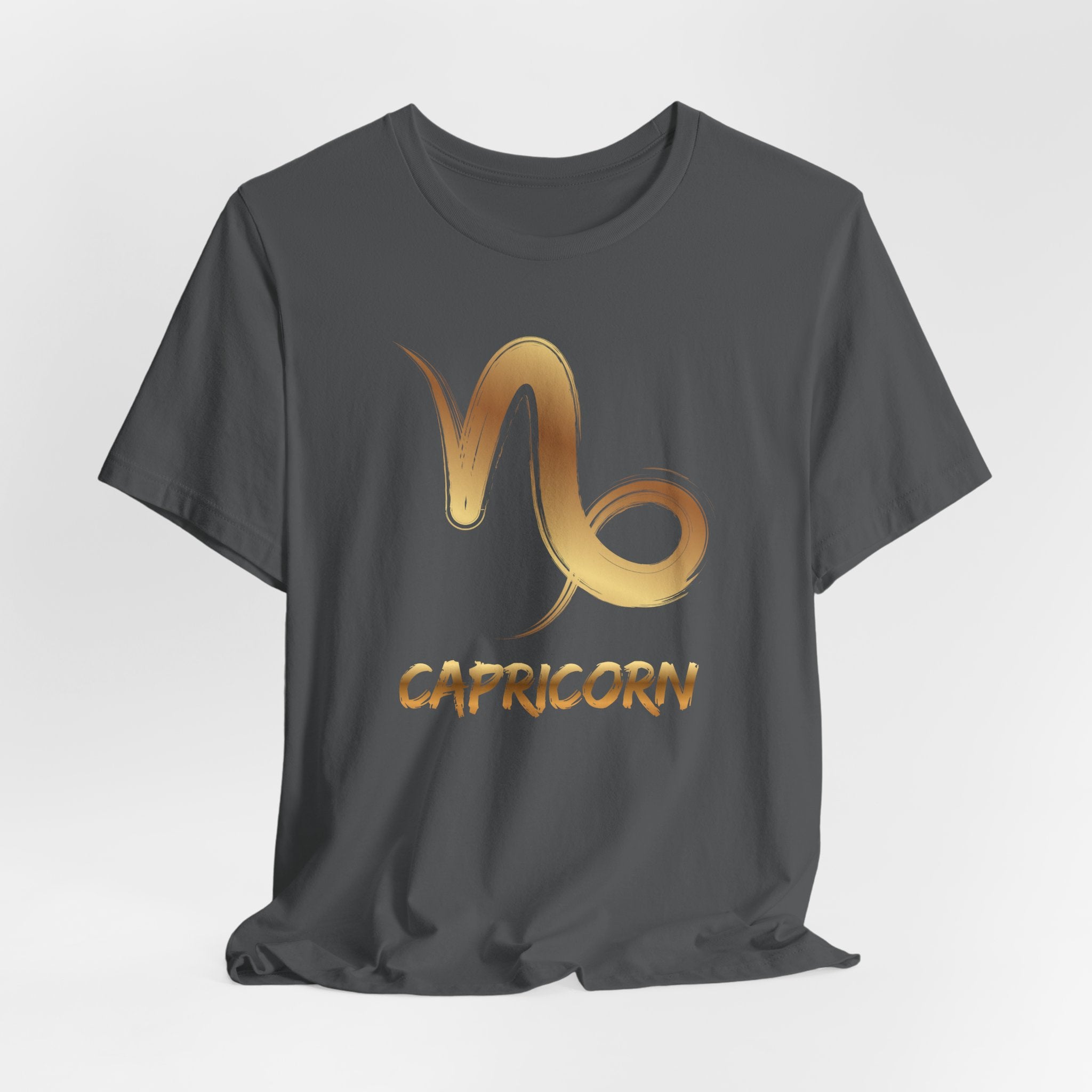 Black t-shirt with gold Capricorn zodiac symbol on a white background