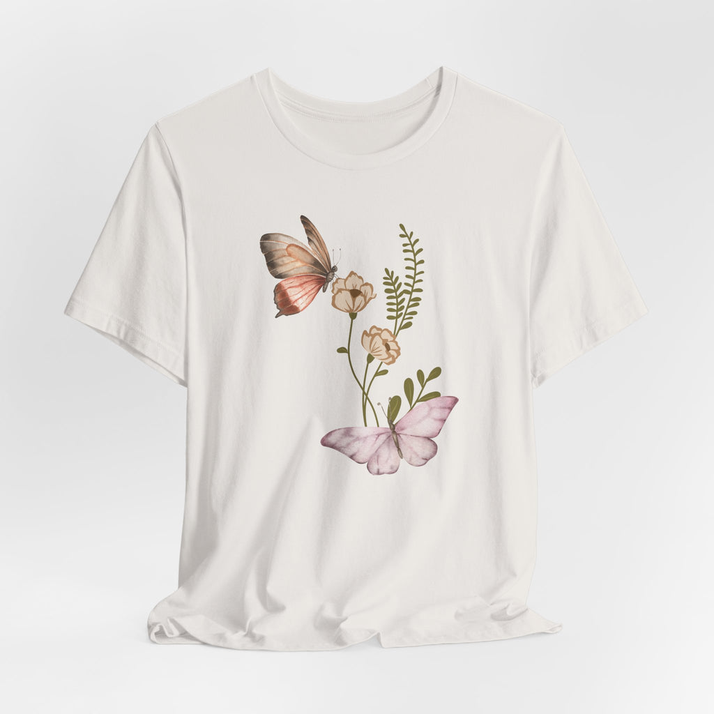 White t-shirt with butterfly and floral design on a light gray background