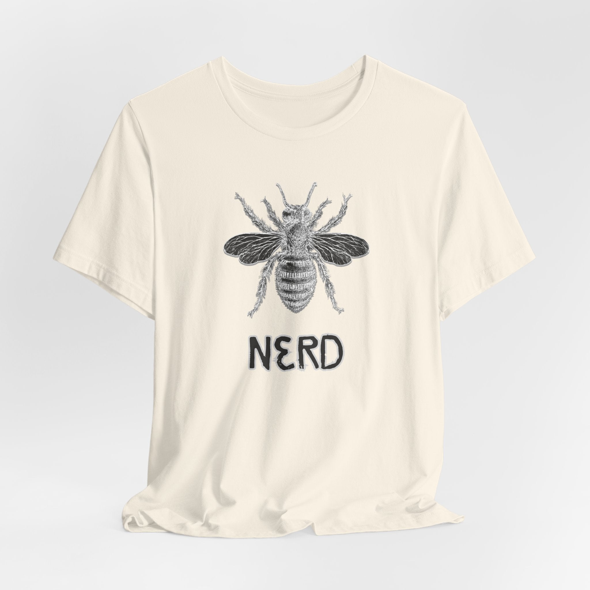 Beige t-shirt with a bee graphic and 'NERD' text on a light gray background