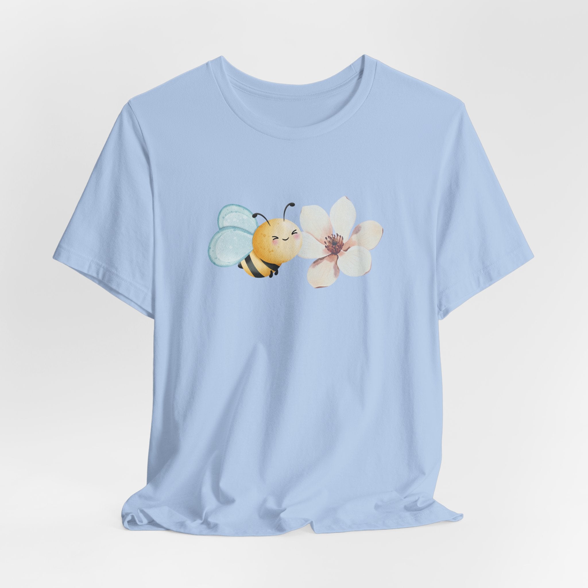 Light blue t-shirt with a bee and flower design on a white background