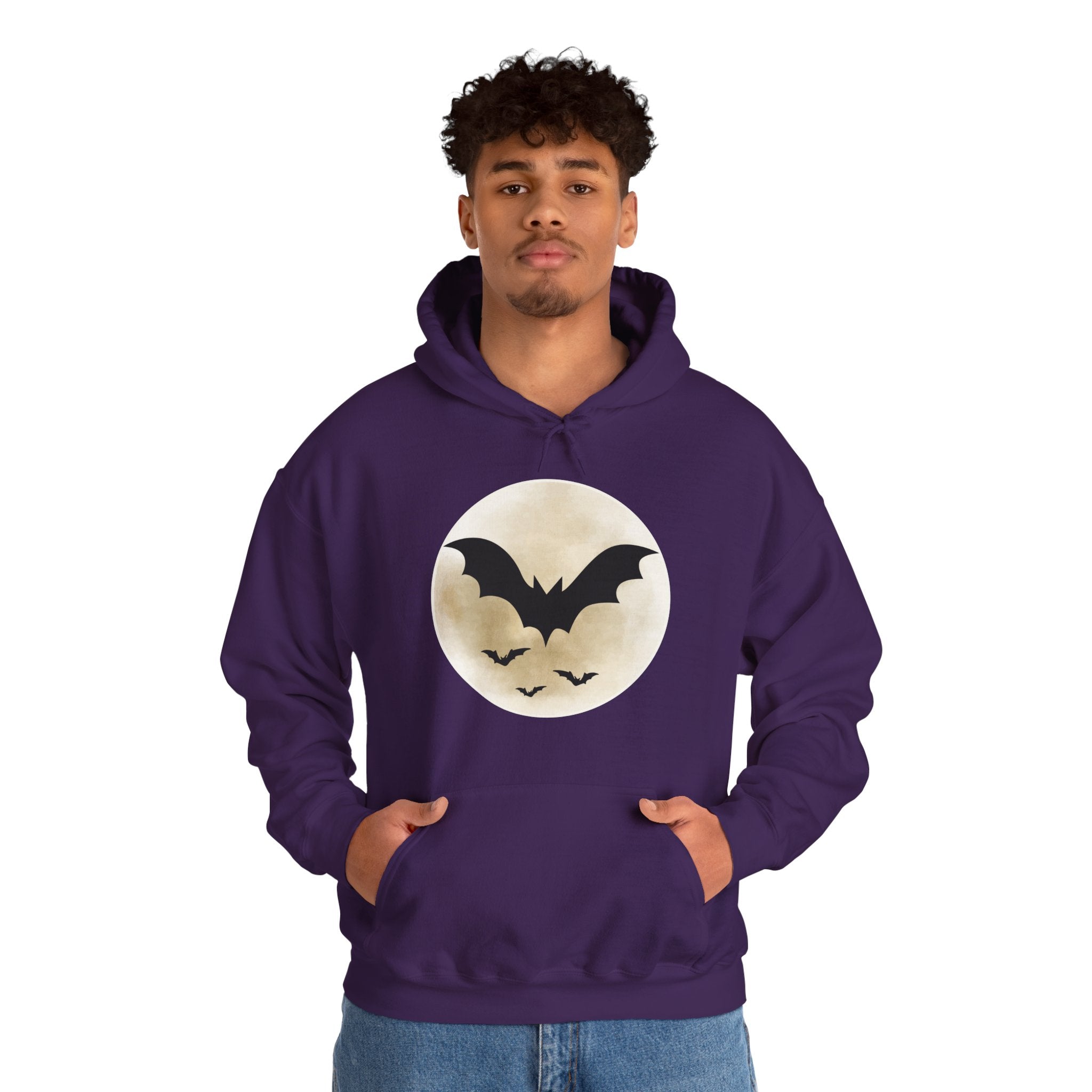 Person wearing a purple hoodie with a bat and moon design on a white background