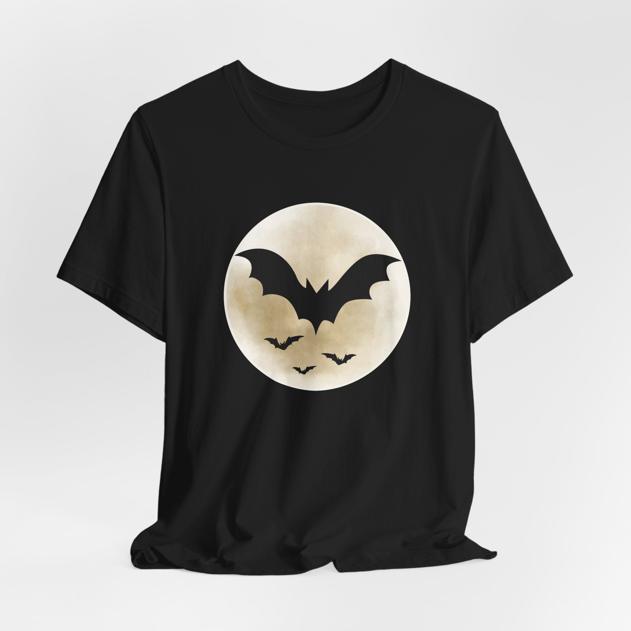 Black t-shirt with full moon and bats design on a light gray background