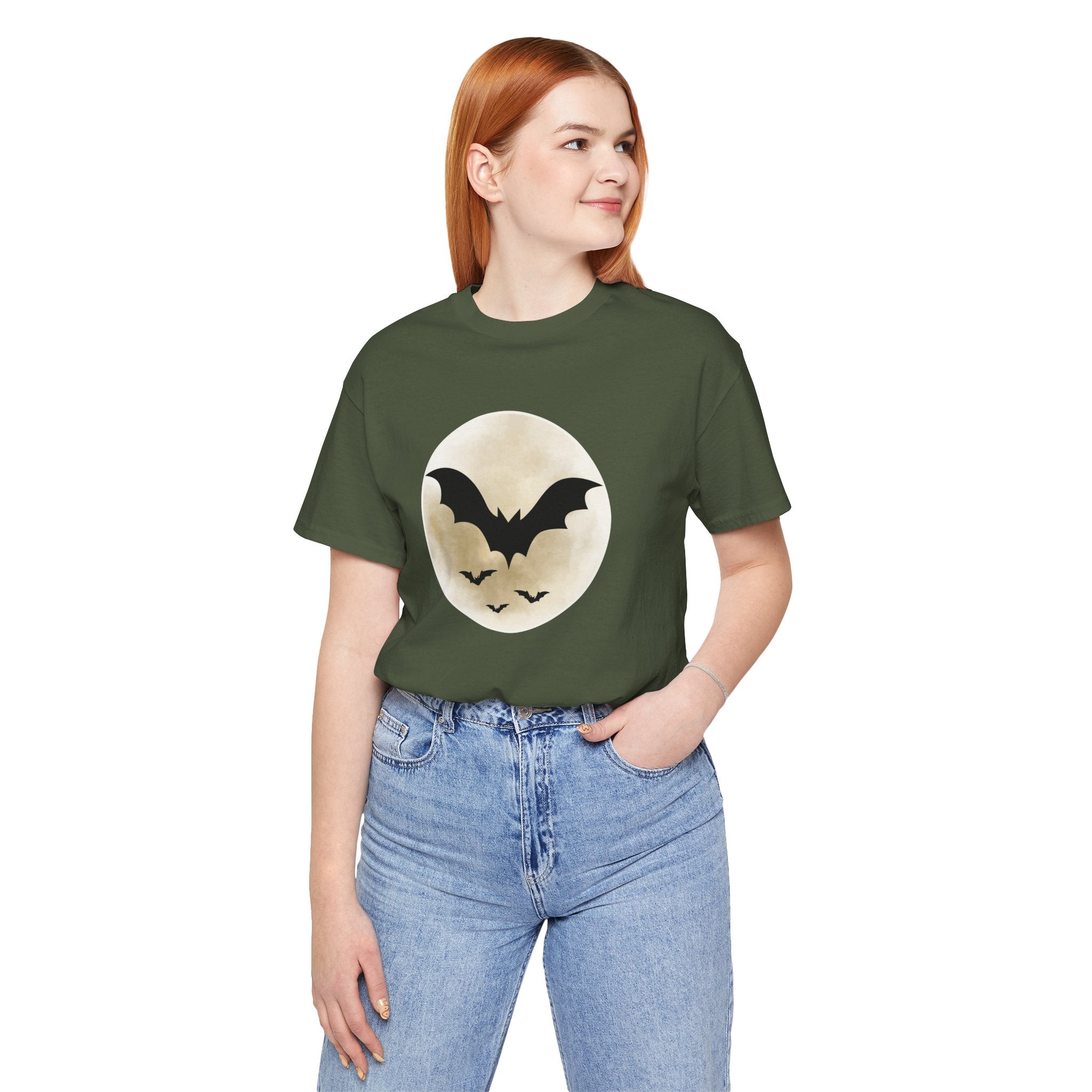 Person wearing a green t-shirt with a bat design on a white background