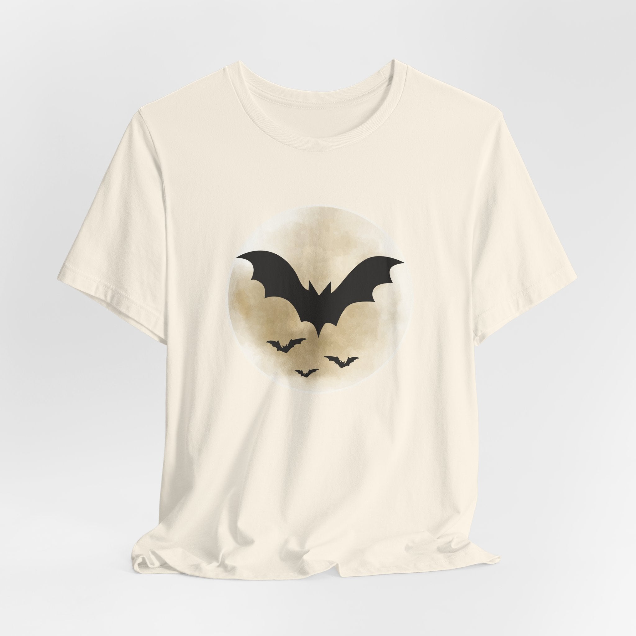 Ivory beige t-shirt with full moon and bats design on a light gray background