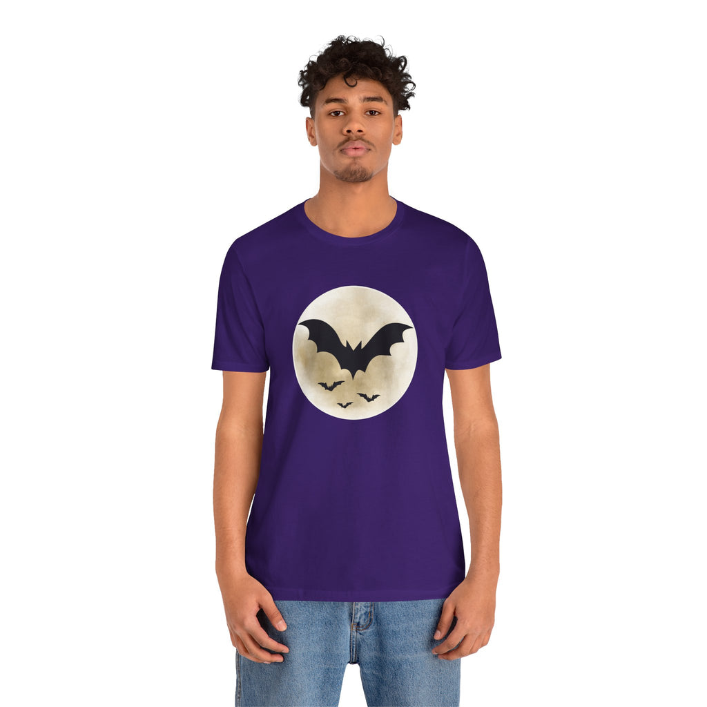 Person wearing a purple t-shirt with a bat design on a white background