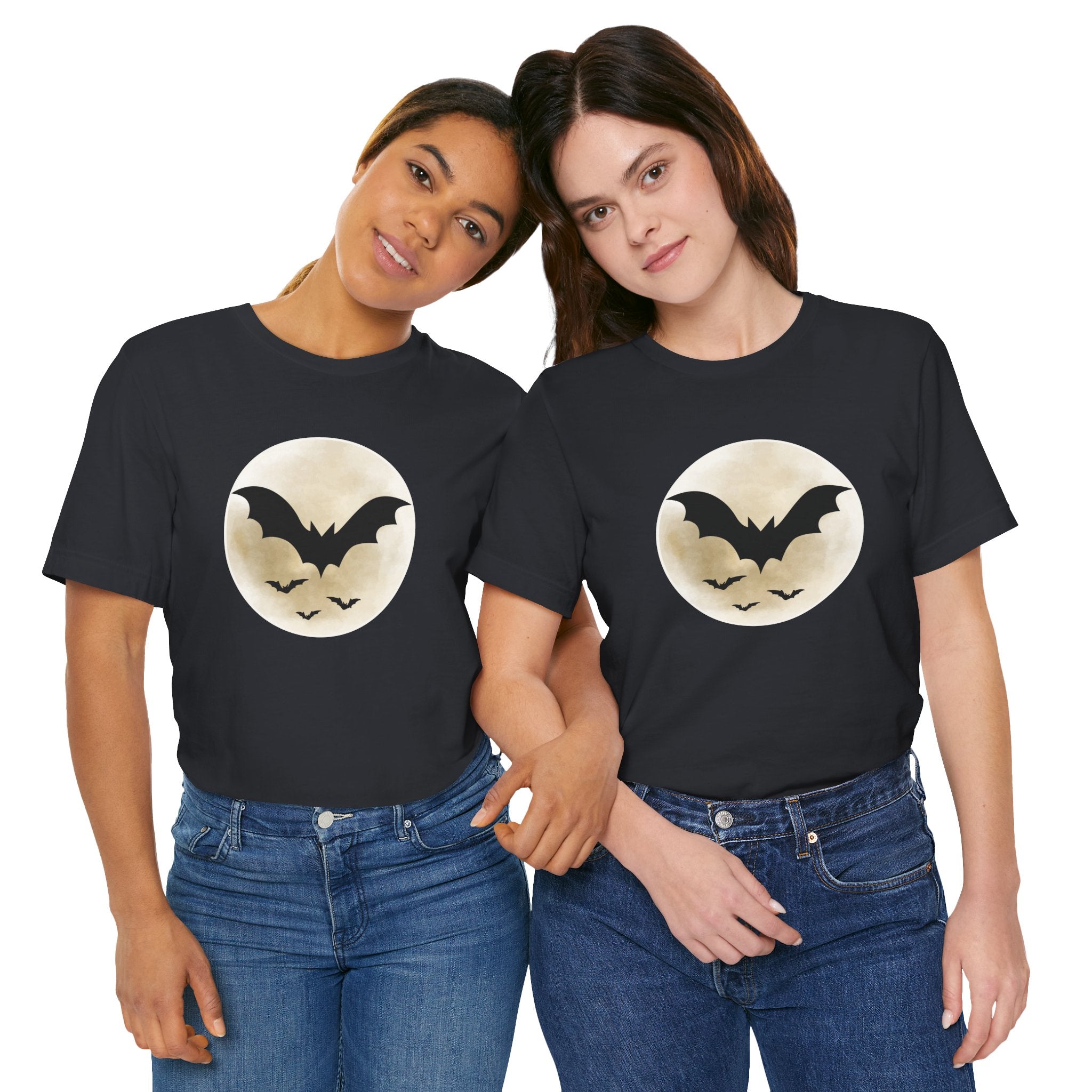 Two people wearing black t-shirts with a moon and bat design on a white background
