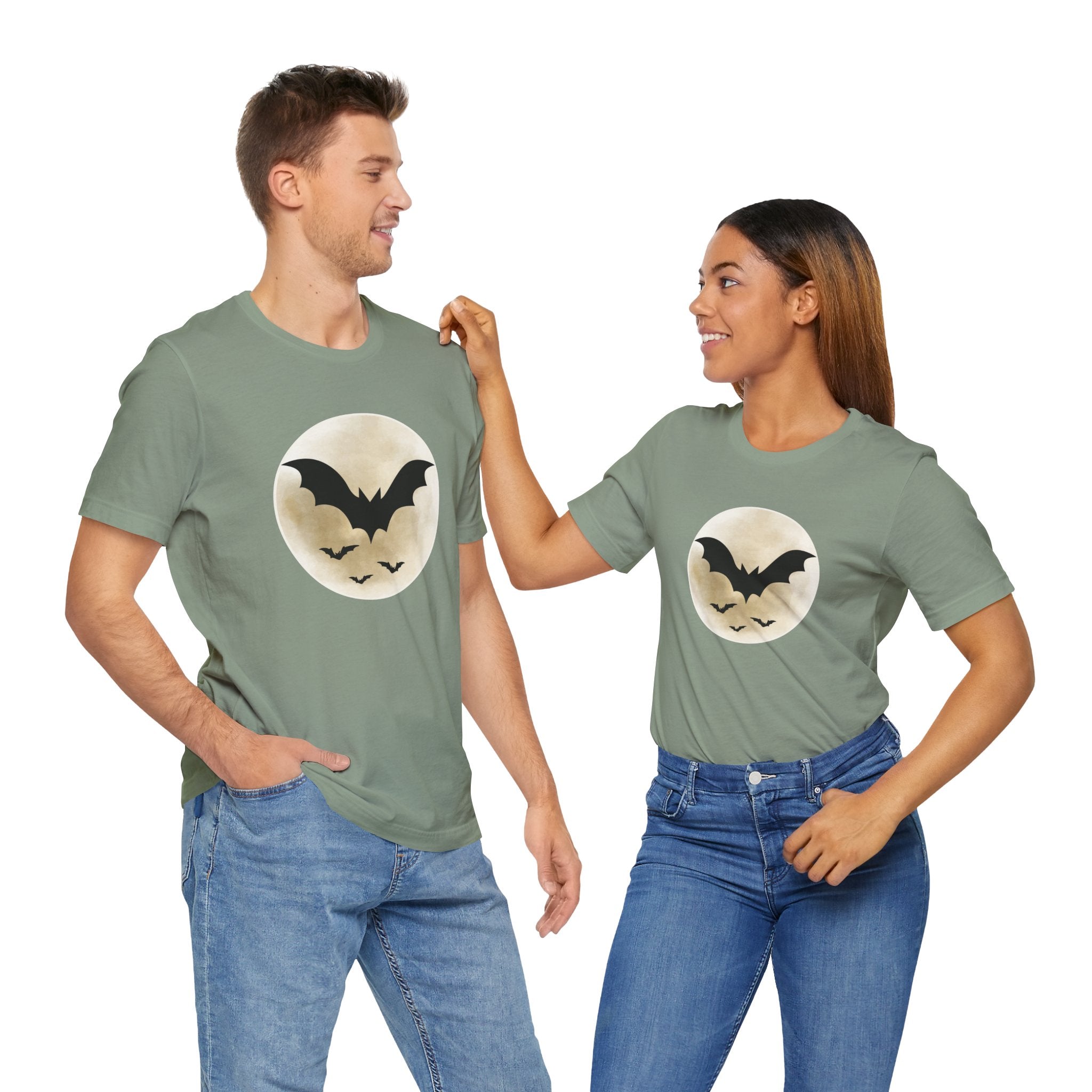 Two people wearing matching green t-shirts with a bat design on a white background