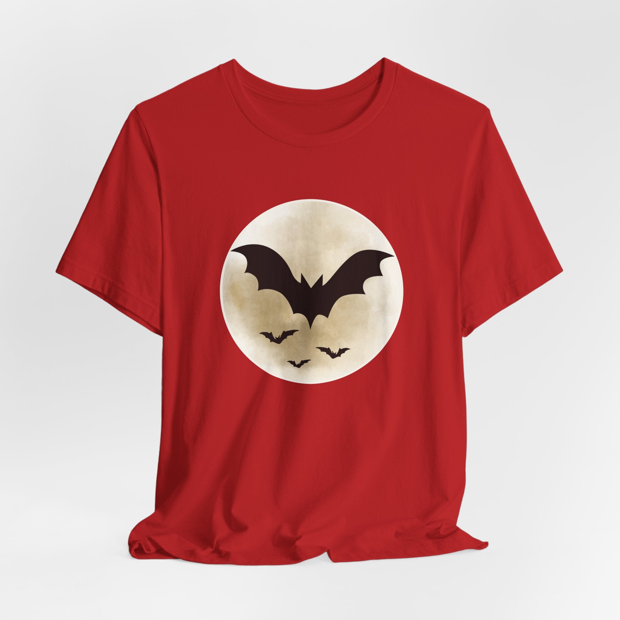 Red t-shirt with full moon and bats design on a light gray background