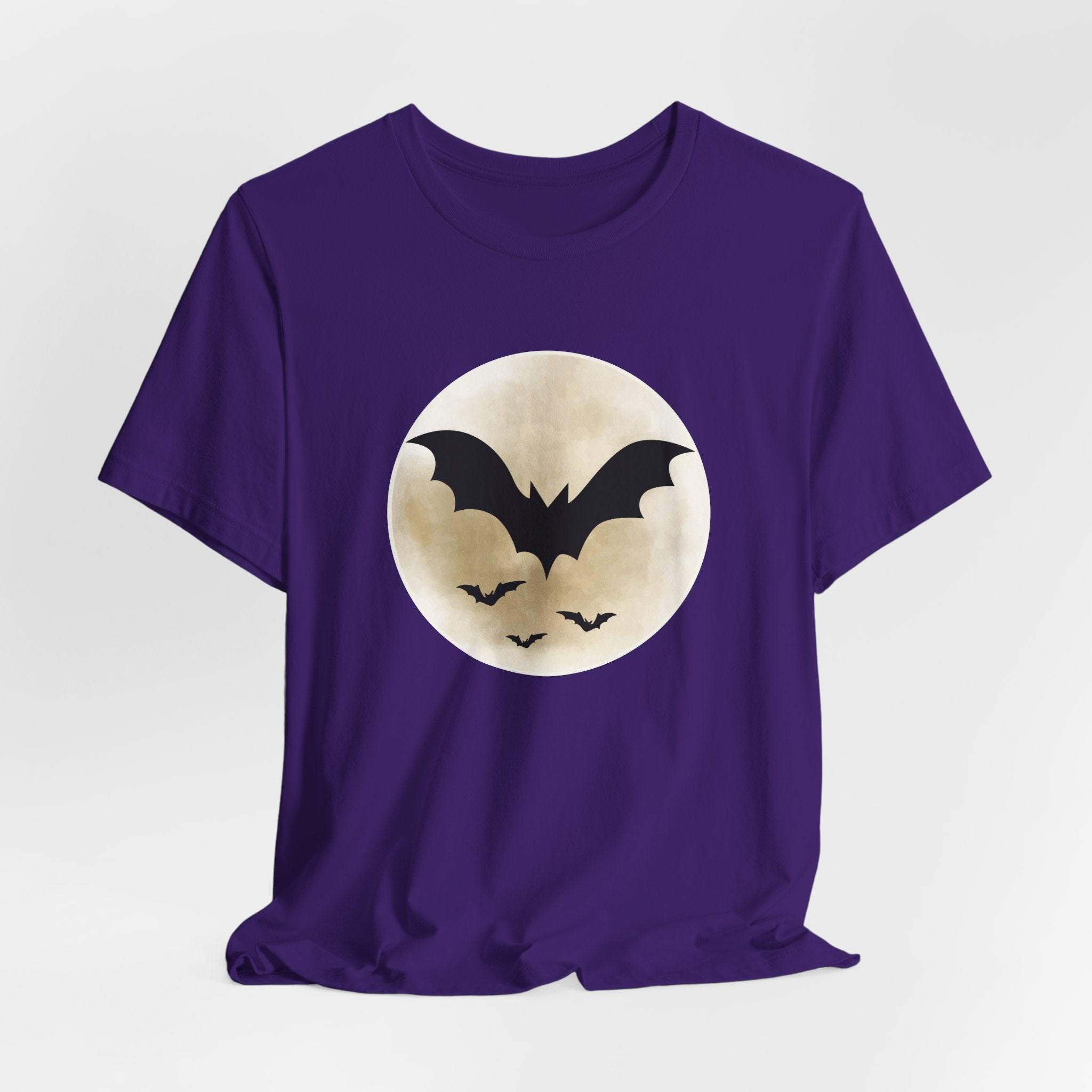 Purple t-shirt with full moon and bats design on a light gray background