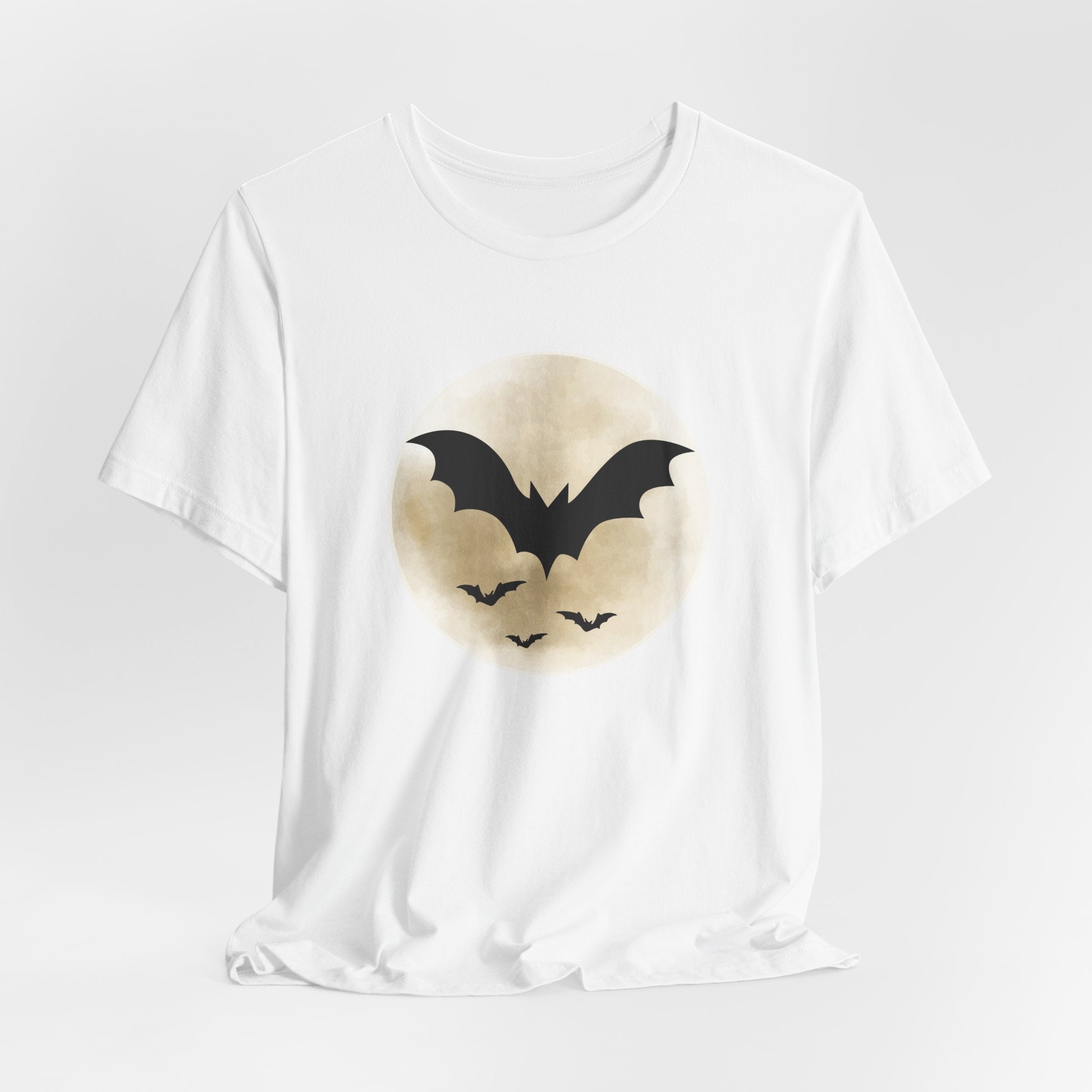White t-shirt with full moon and bats design on a light gray background