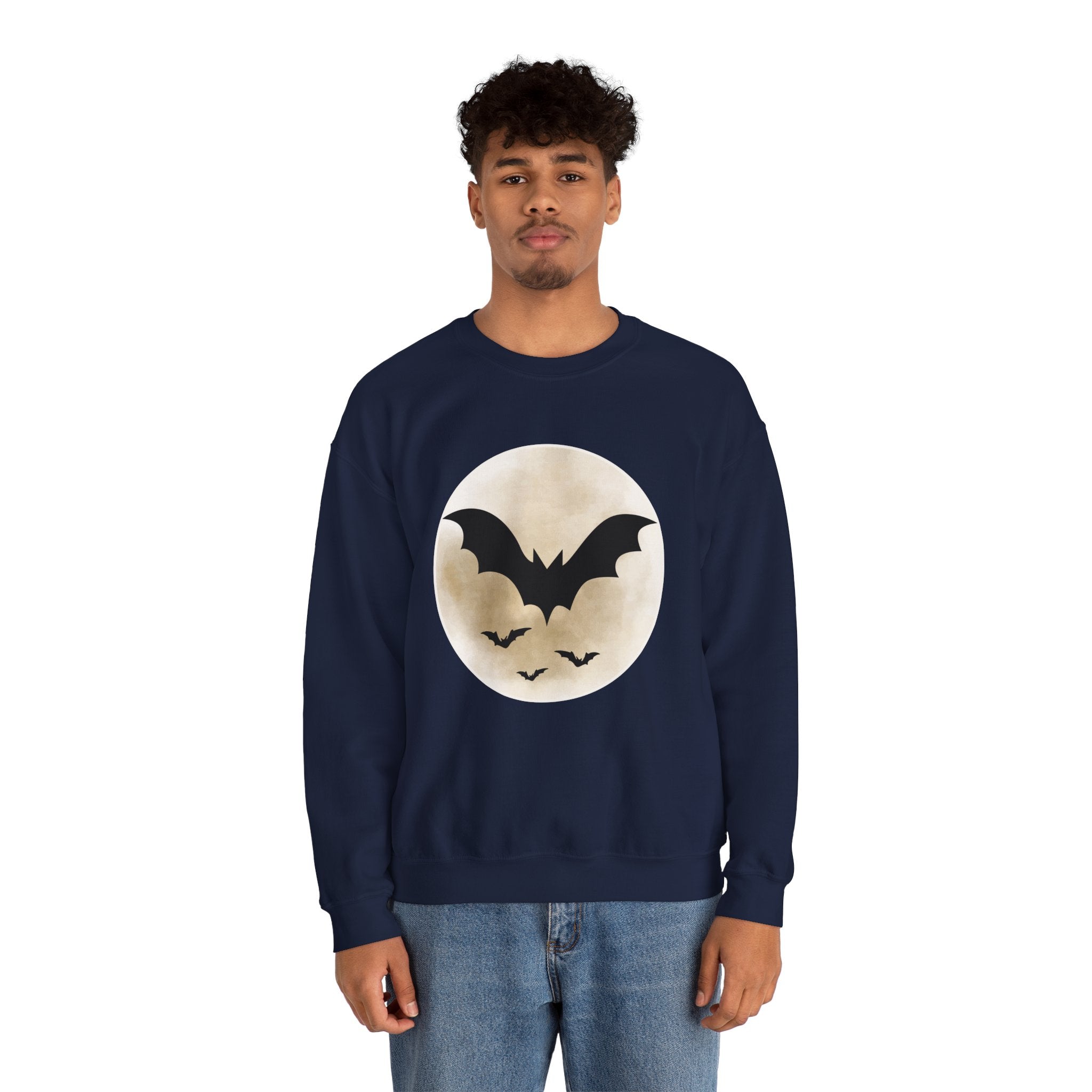 Person wearing a navy blue sweatshirt with a bat design on a white background