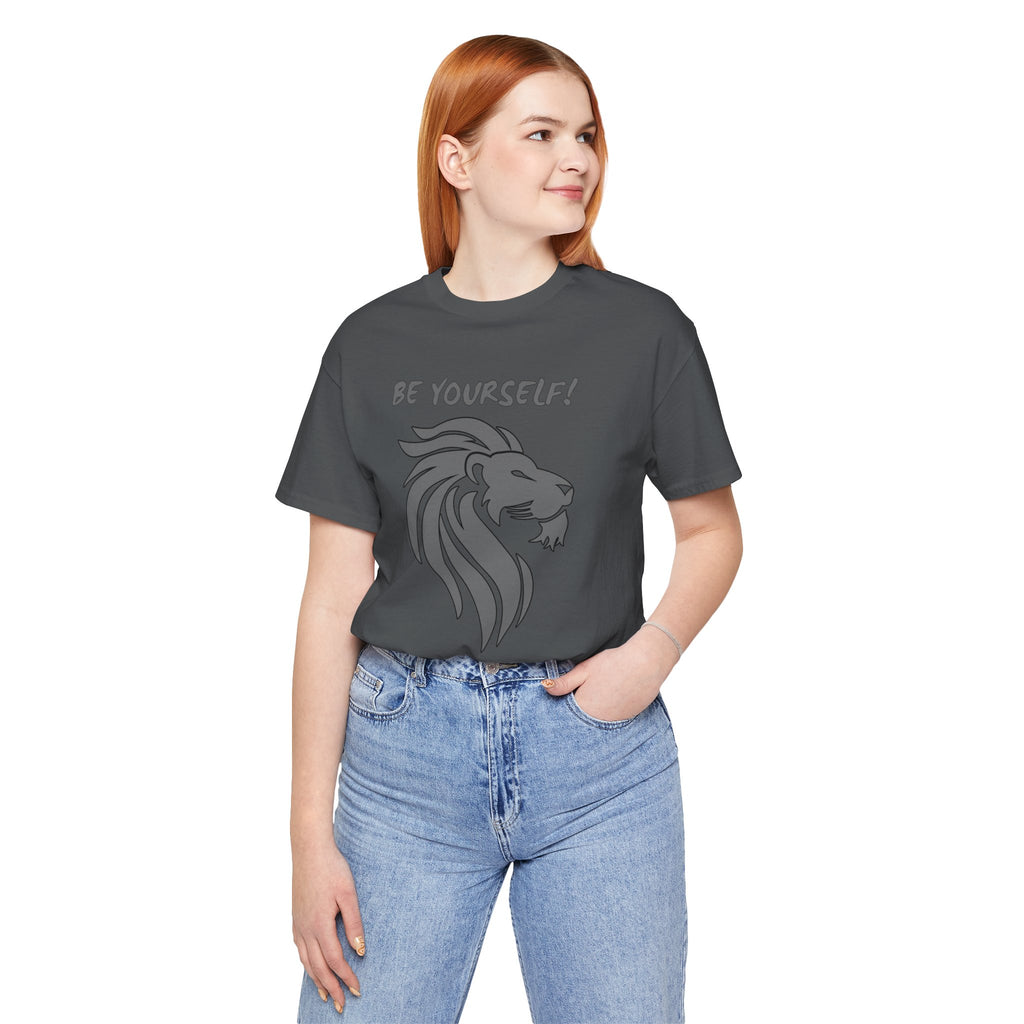 Person wearing a dark gray t-shirt with a lion graphic and 'BE YOURSELF!' text on a white background