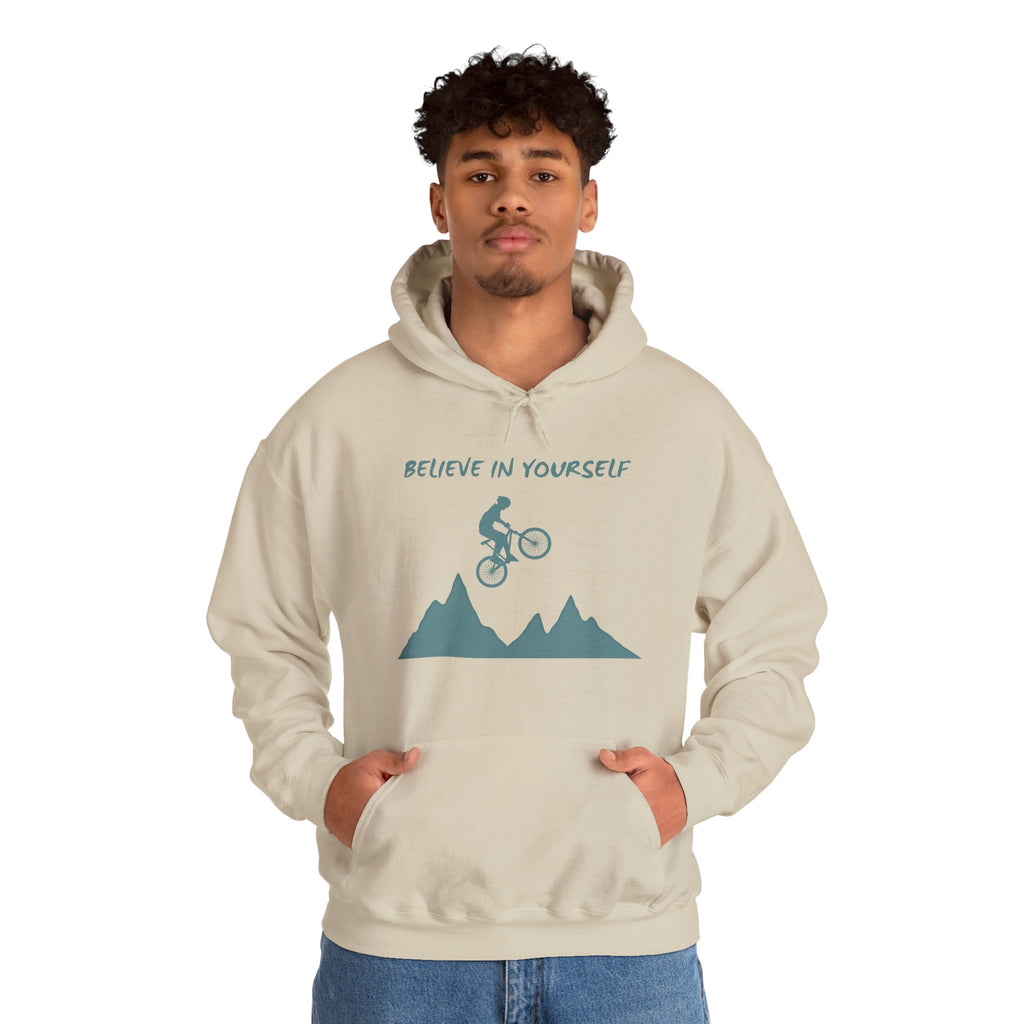 Person wearing a beige hoodie with a graphic and text on a white background