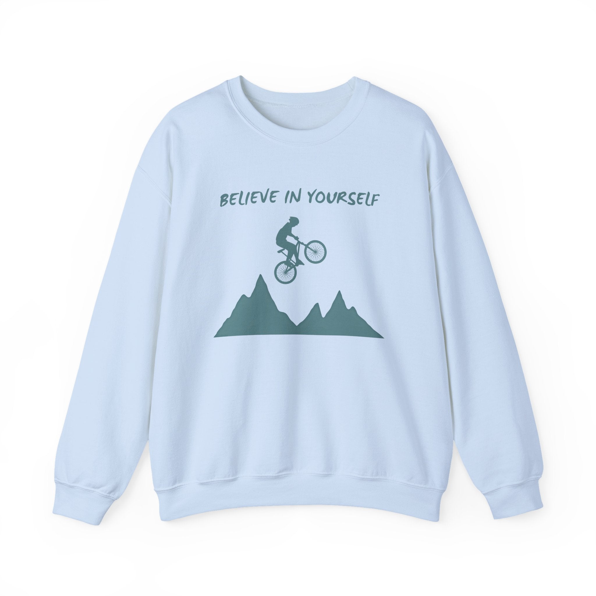 Light blue sweatshirt with mountain and bicycle graphic and 'Believe in Yourself' text on a white background