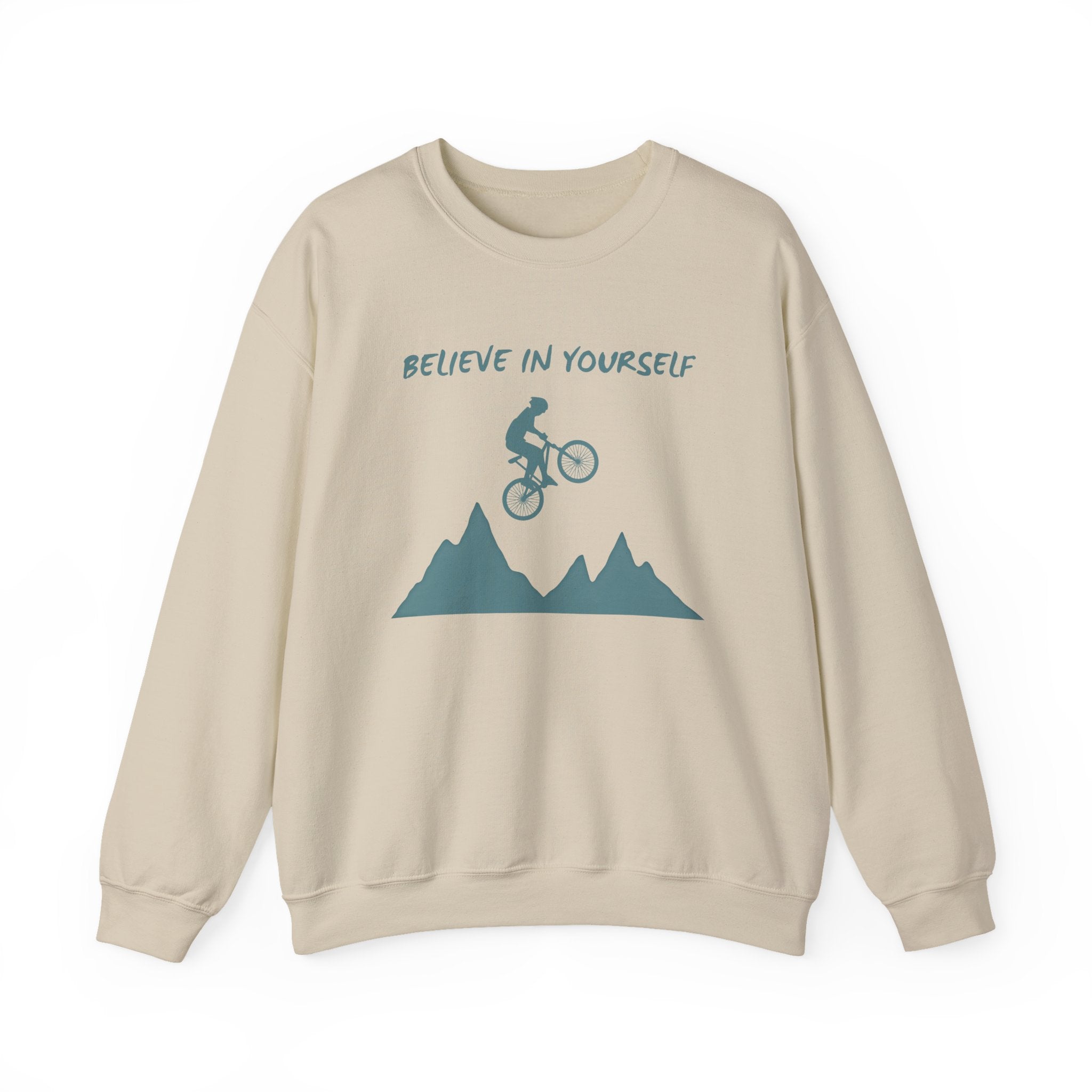 Beige sweatshirt with mountain and cyclist graphic and 'Believe in Yourself' text on a white background