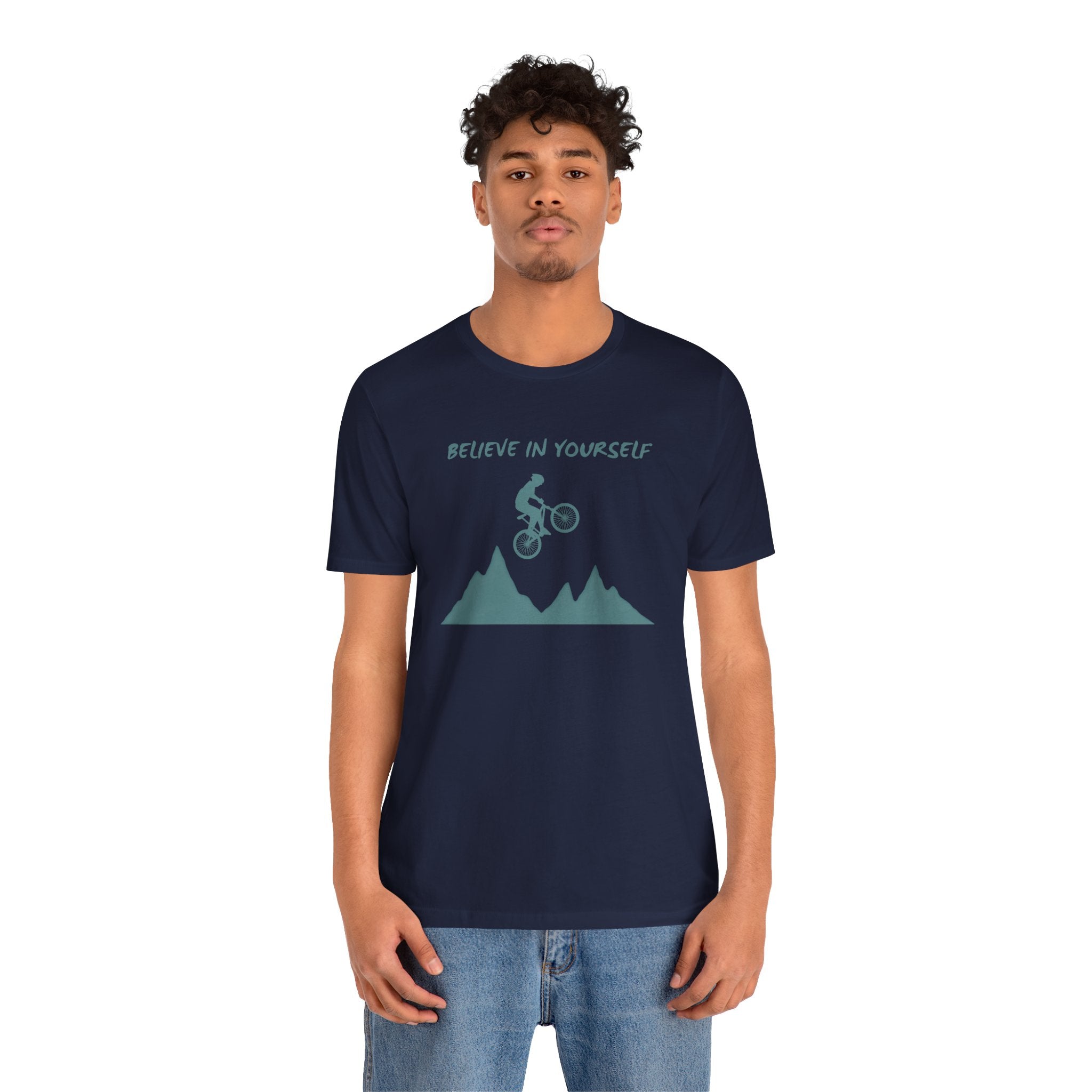Person wearing a navy blue t-shirt with a graphic and text on a white background