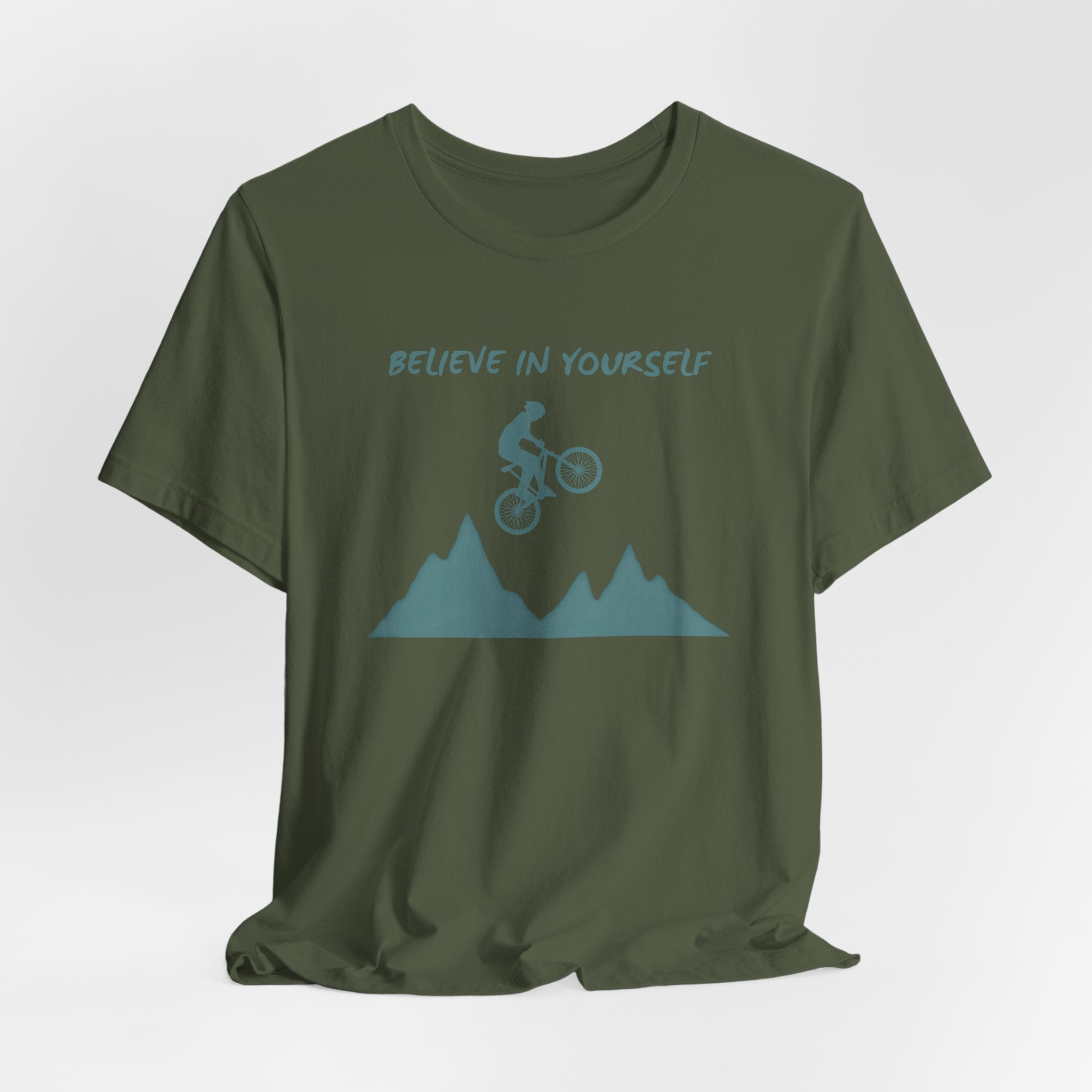 Green t-shirt with mountain bike graphic and 'Believe in Yourself' text on a white background