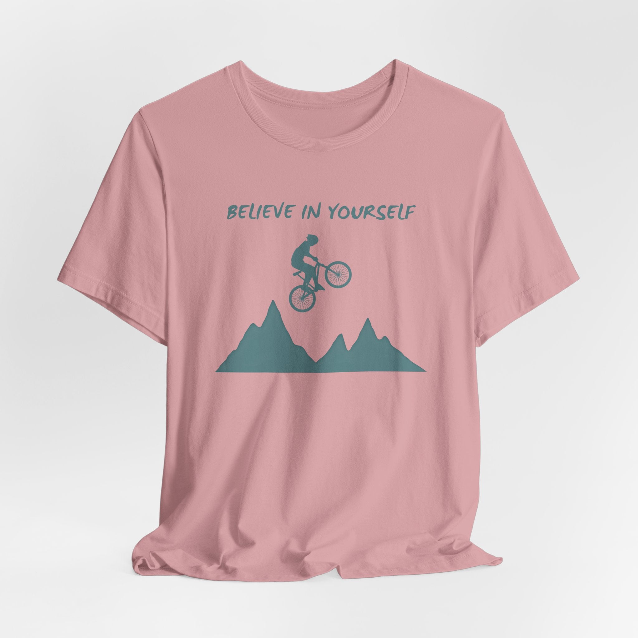 Orchid pink t-shirt with mountain bike graphic and 'Believe in Yourself' text on a light gray background