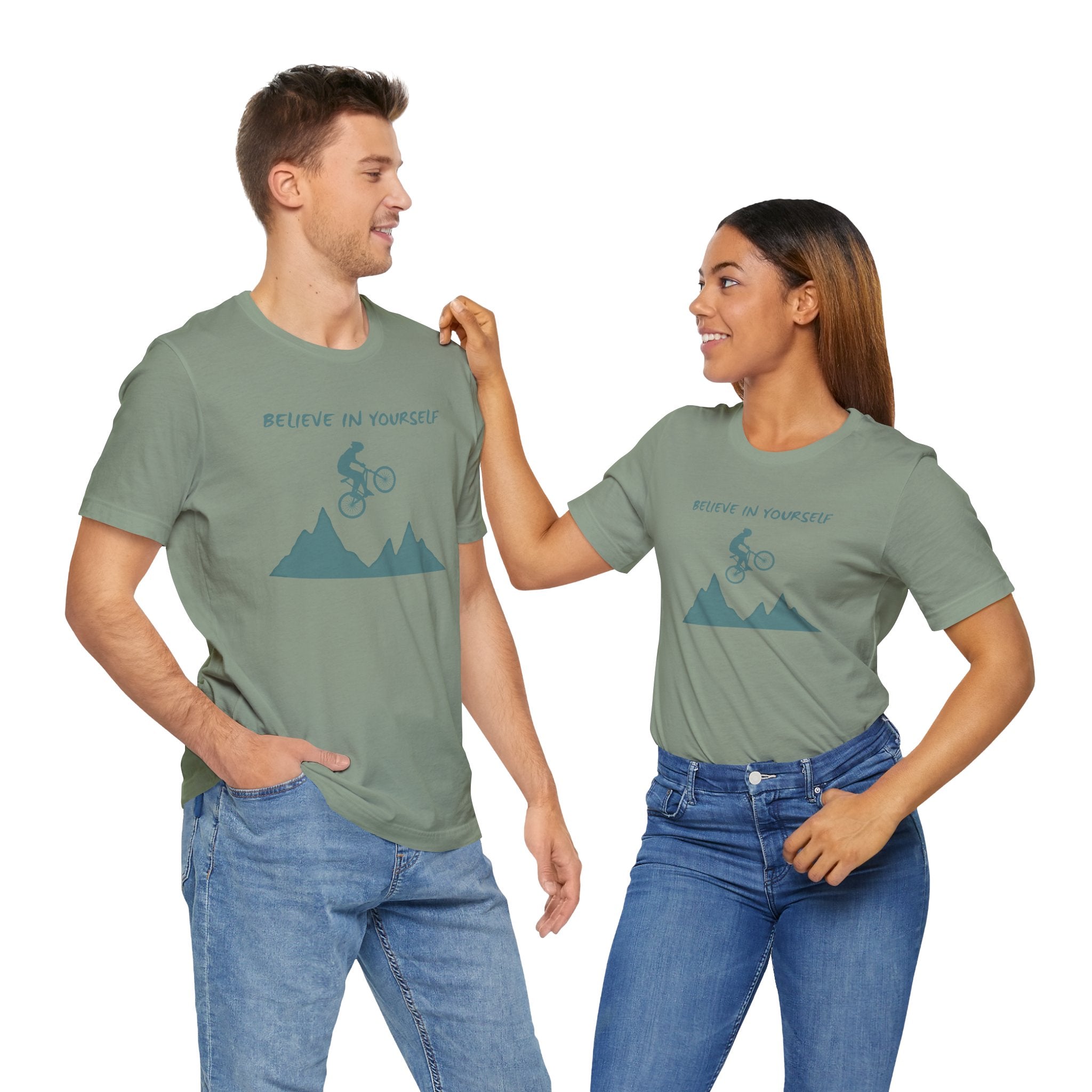 Two people wearing matching green t-shirts with a graphic design on a white background