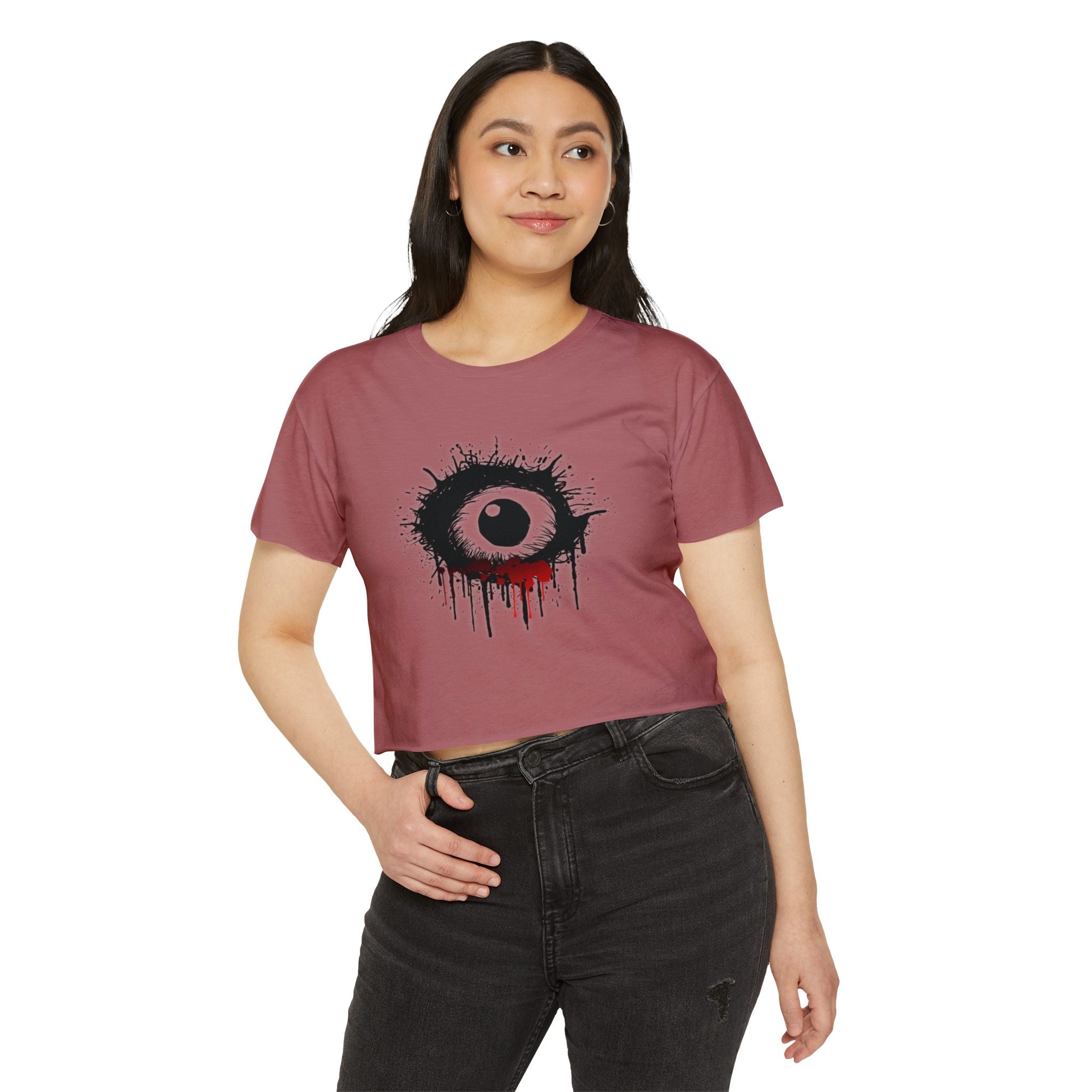 Woman wearing a maroon t-shirt with a graphic design on a white background