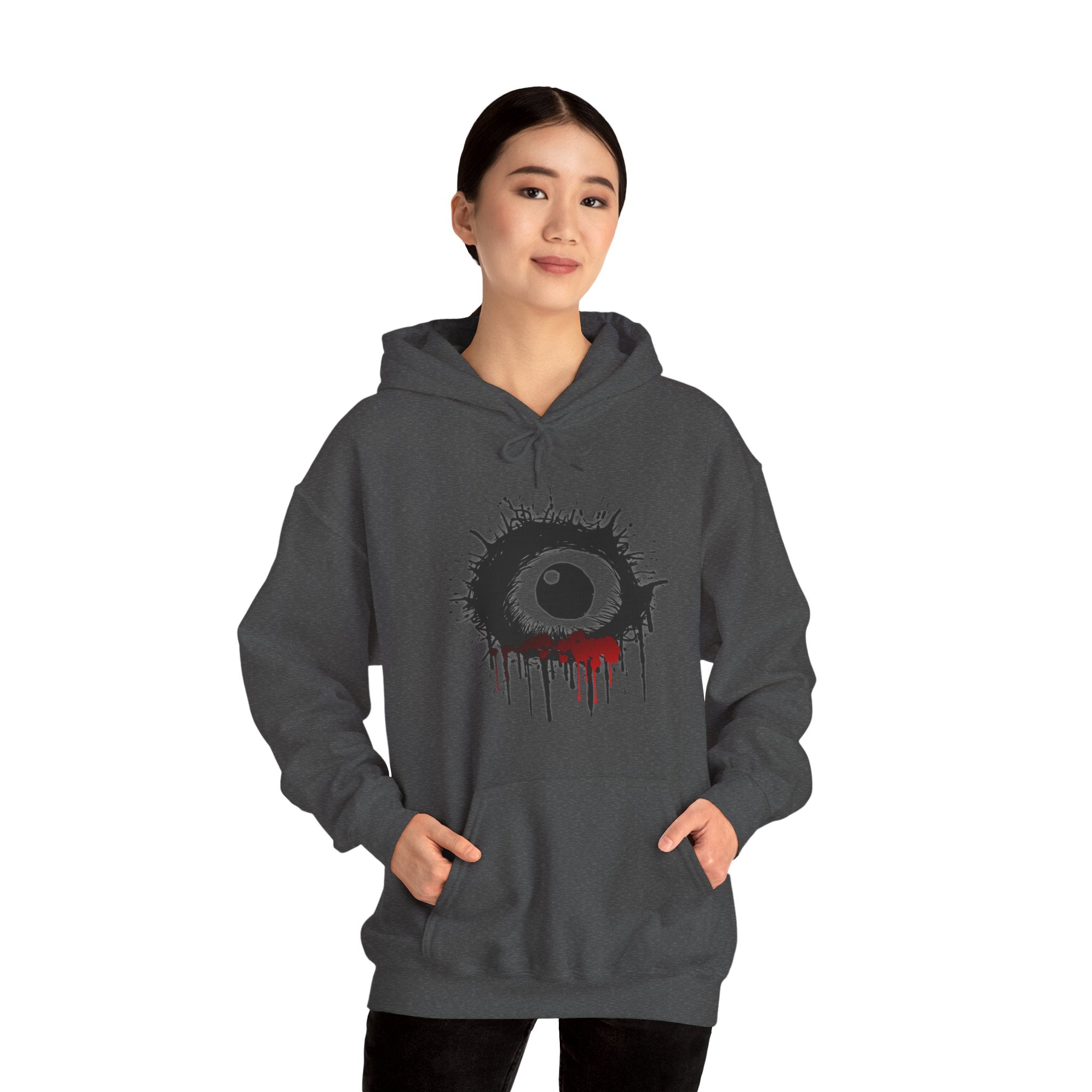 Person wearing a dark gray hoodie with a unique design on a white background