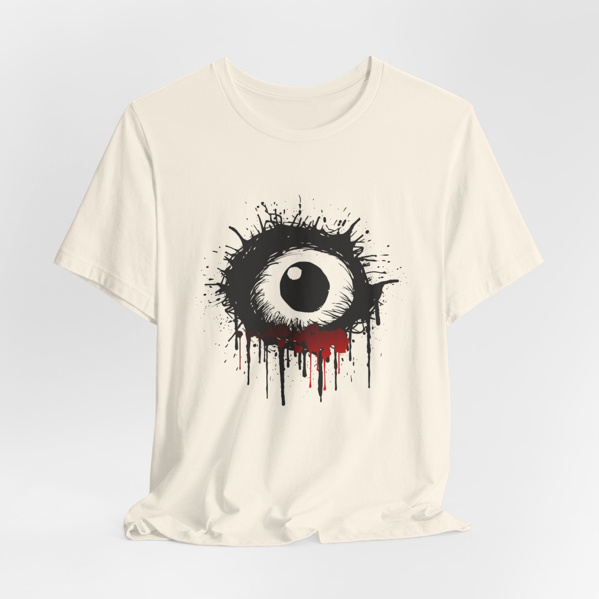 Ivory beige t-shirt with an eye graphic design on a light gray background