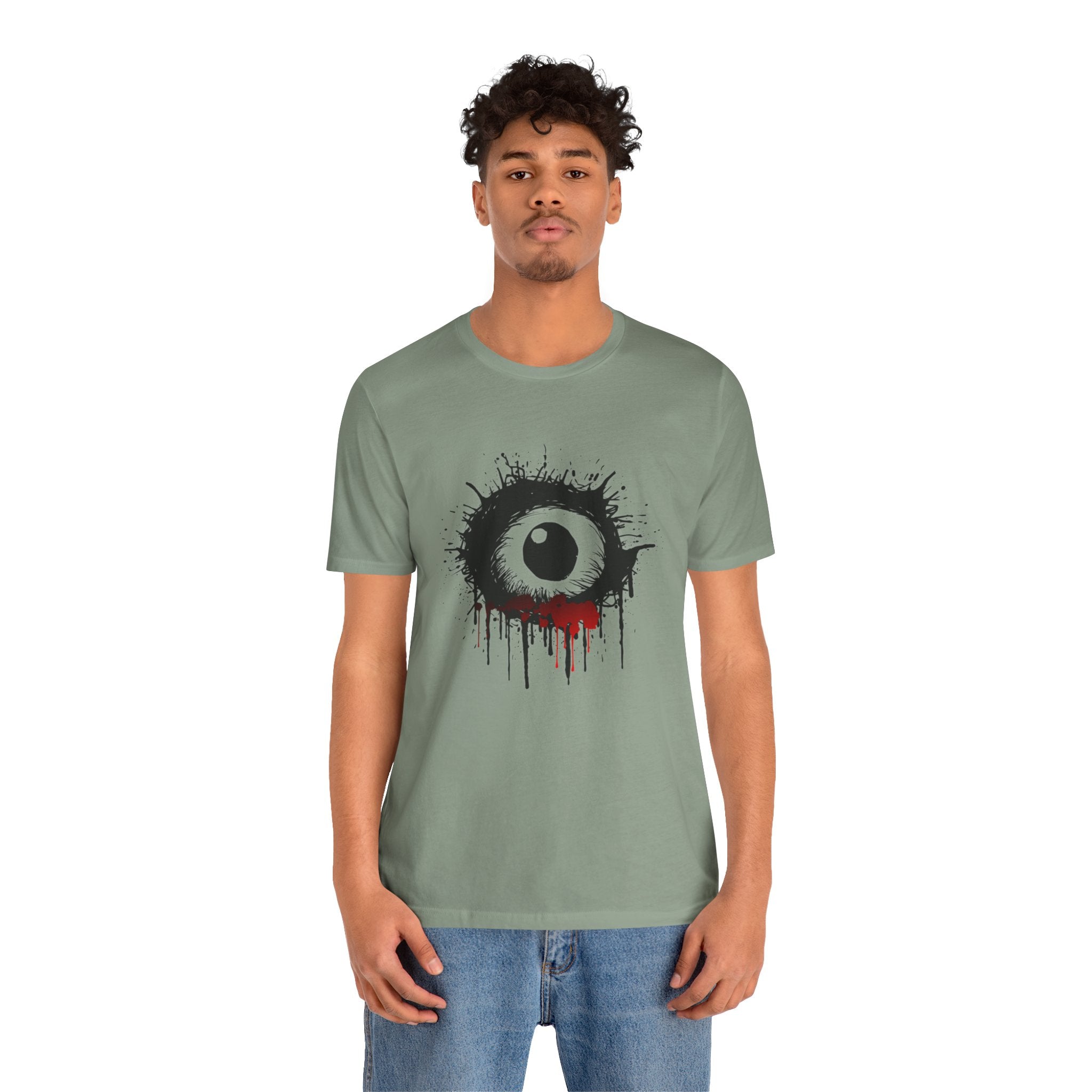 Person wearing a green t-shirt with a black and white graphic design on a white background