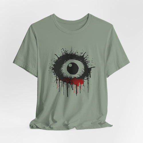 Sage green t-shirt with a black and white eye design on a light gray background