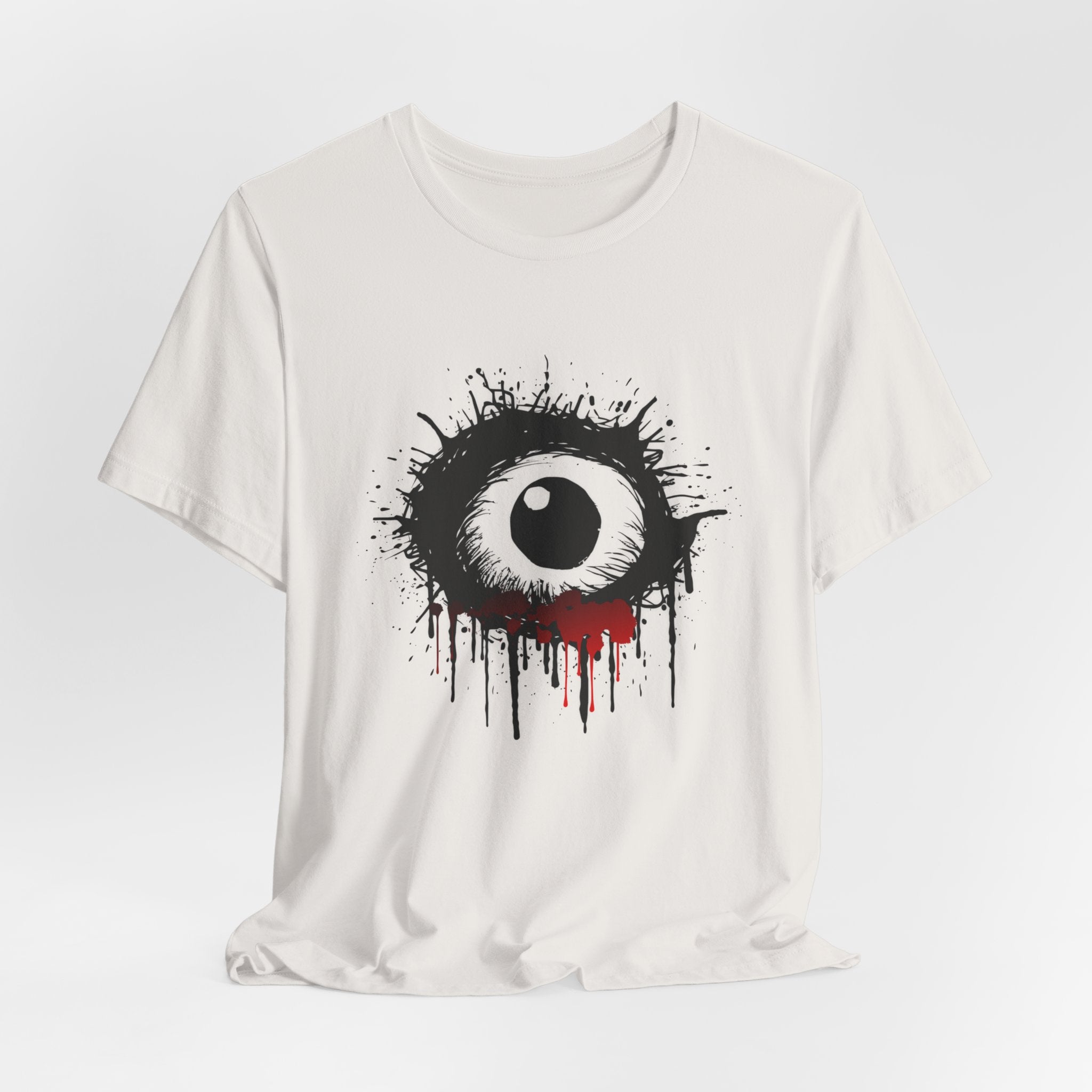 Vintage white t-shirt with a black and white eye design with red accents on a light gray background
