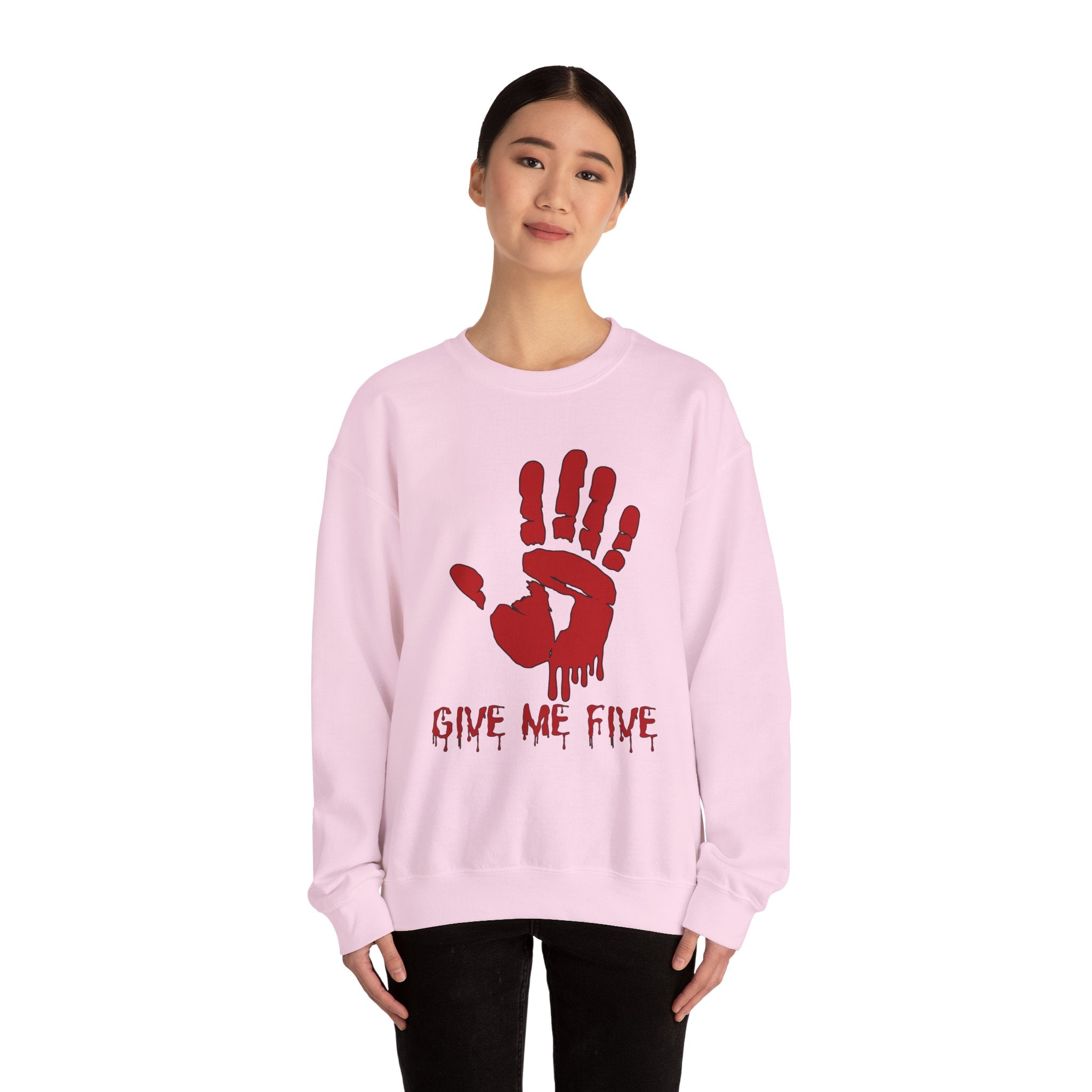 Person wearing a pink sweatshirt with a red hand print and text on a white background