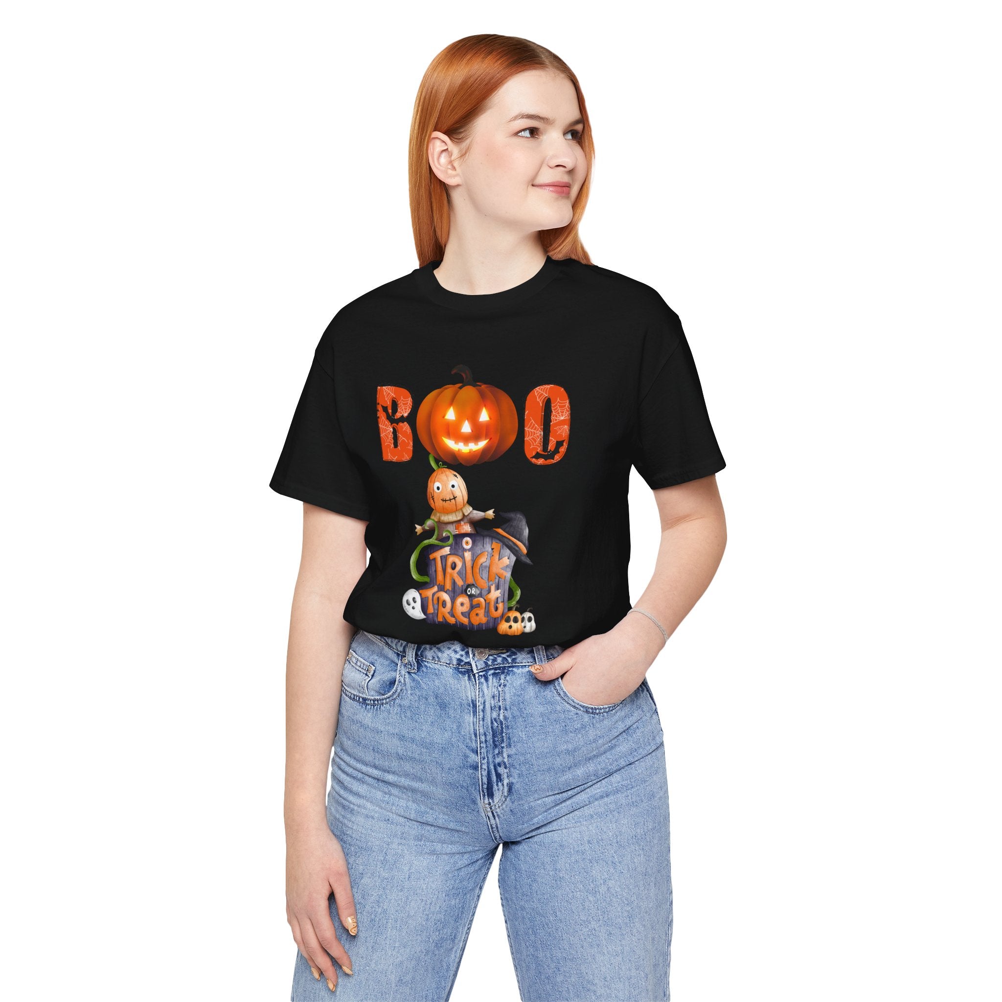Person wearing a black Halloween-themed t-shirt with pumpkins and text on a white background