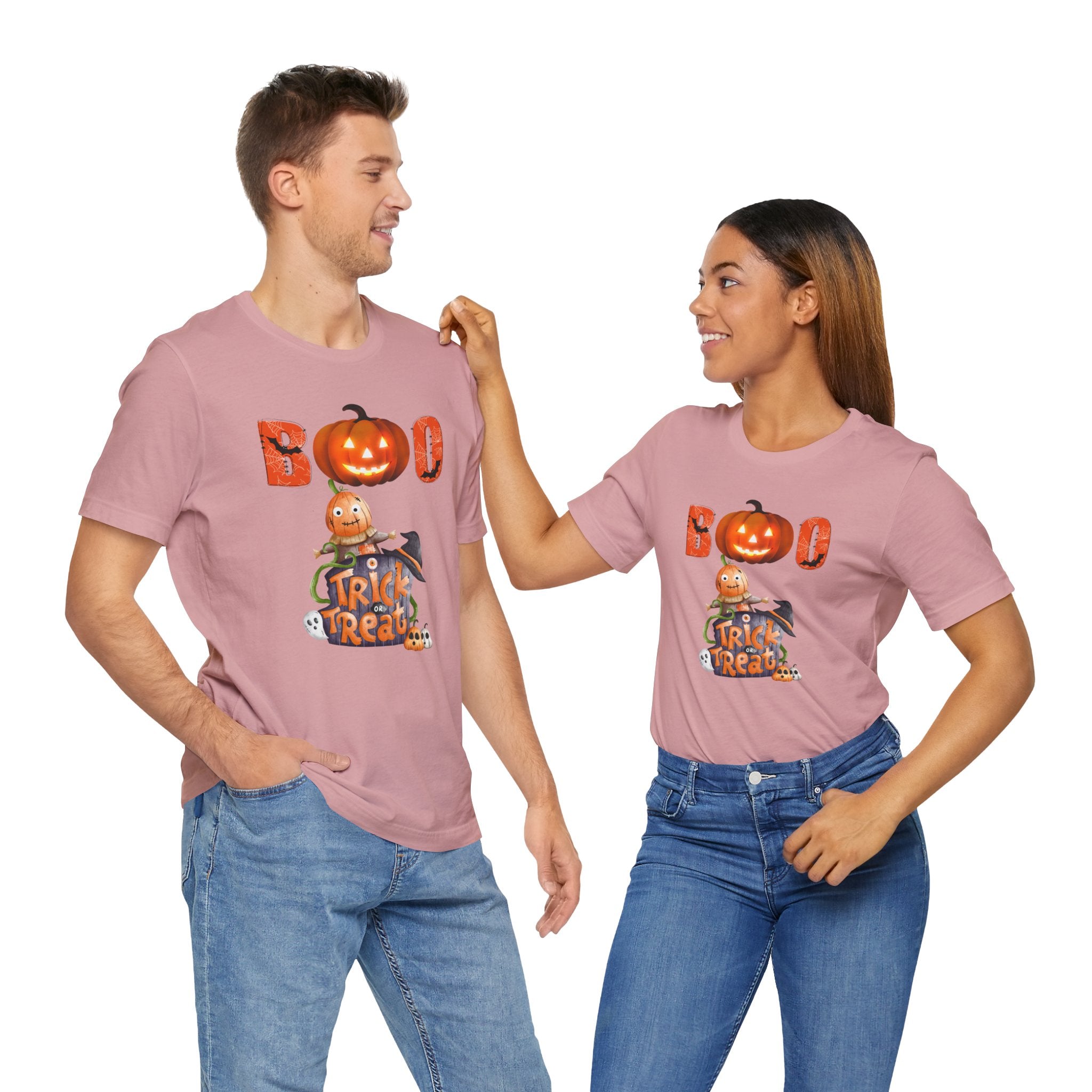 Two people wearing matching pink t-shirts with Halloween designs on a white background