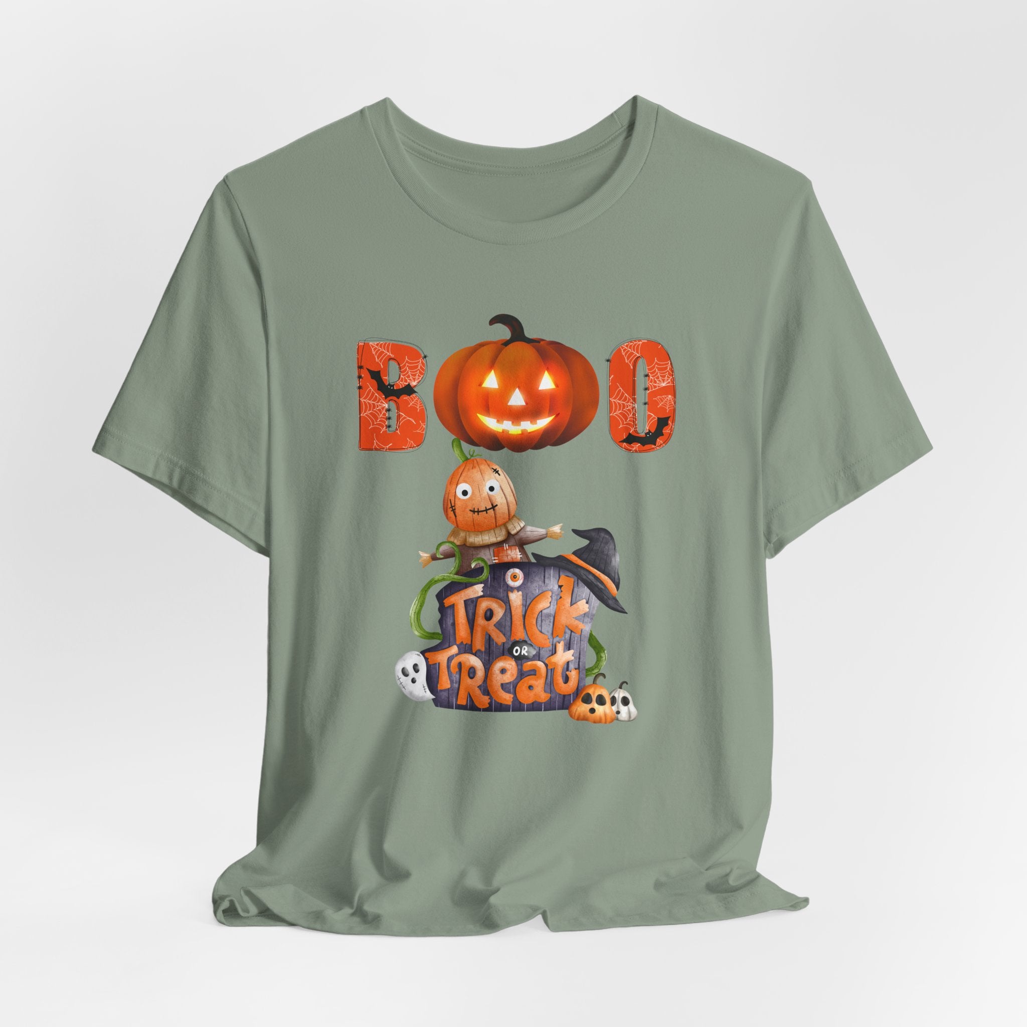 Sage green t-shirt with Halloween-themed design featuring a ghost and pumpkin and boo text on a white background