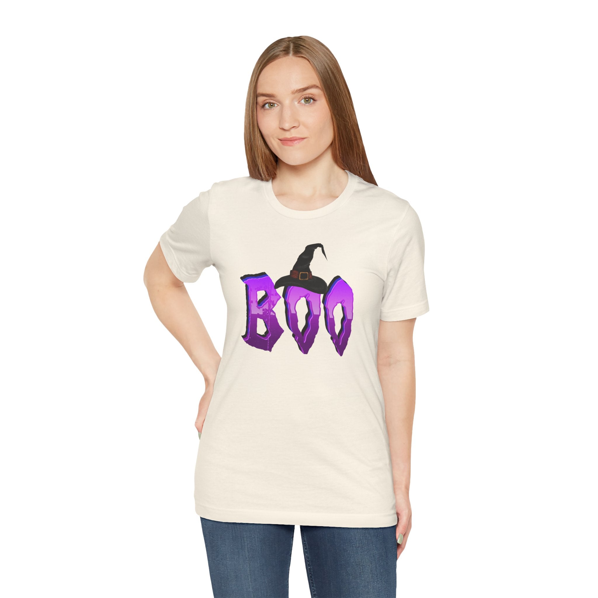 Woman wearing a white t-shirt with 'BOO' in purple and a witch hat graphic on a white background