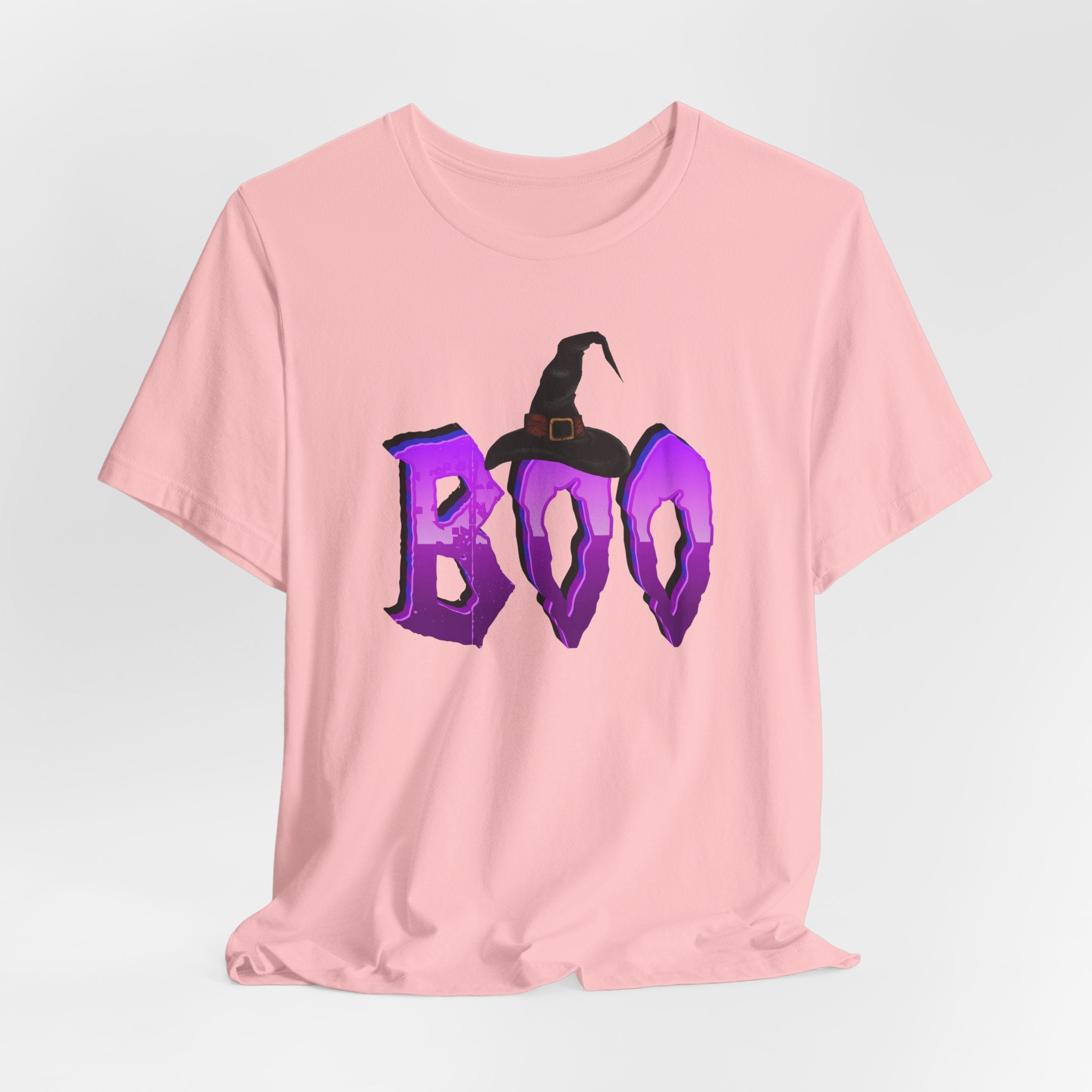 Pink t-shirt with purple 'BOO' text and witch hat design on a light gray background
