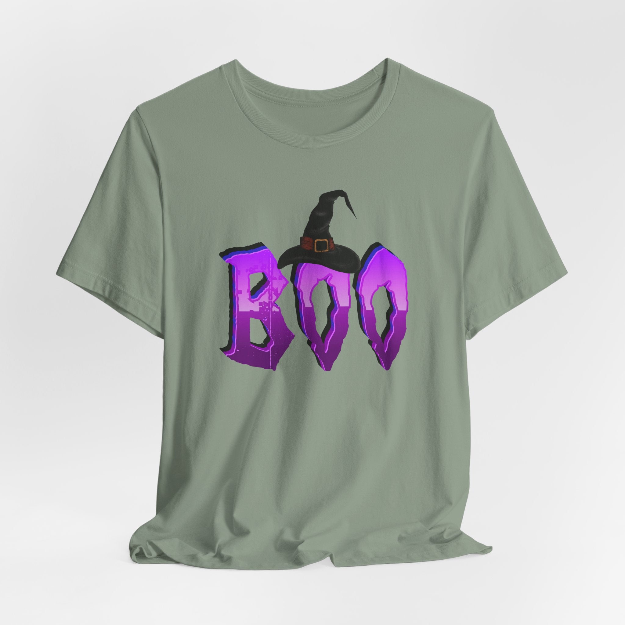 Sage green t-shirt with 'BOO' and witch hat graphic on a light gray background