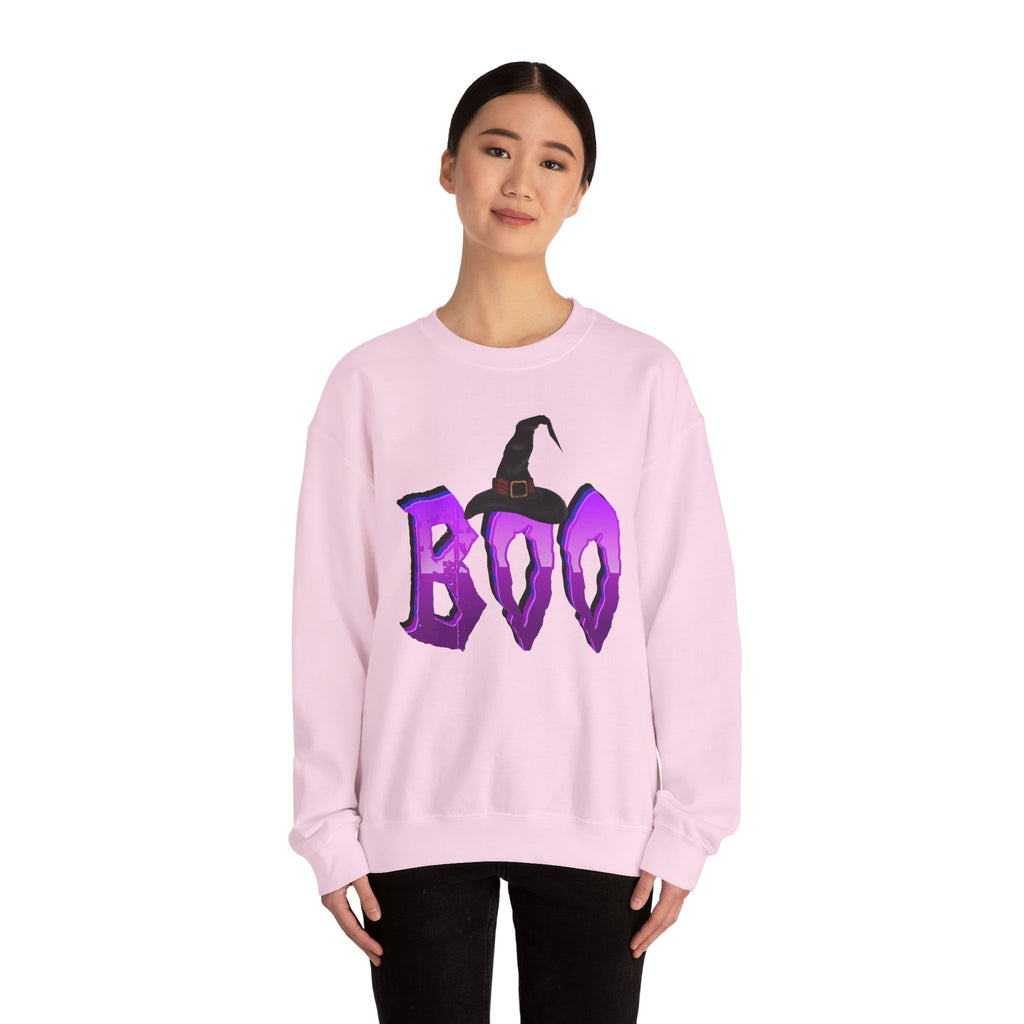 Person wearing a pink sweatshirt with 'BOO' and a witch hat design on a white background