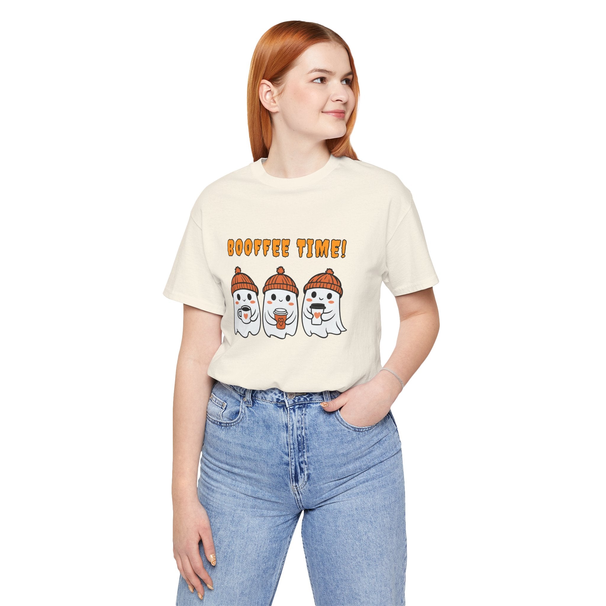 Person wearing a cream t-shirt with ghost and pumpkin design and 'Boo fie Time!' text on a white background