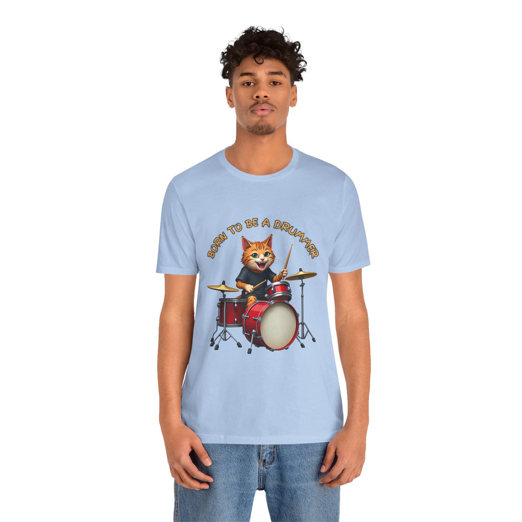 Person wearing a light blue t-shirt with a cat playing drums graphic and text.