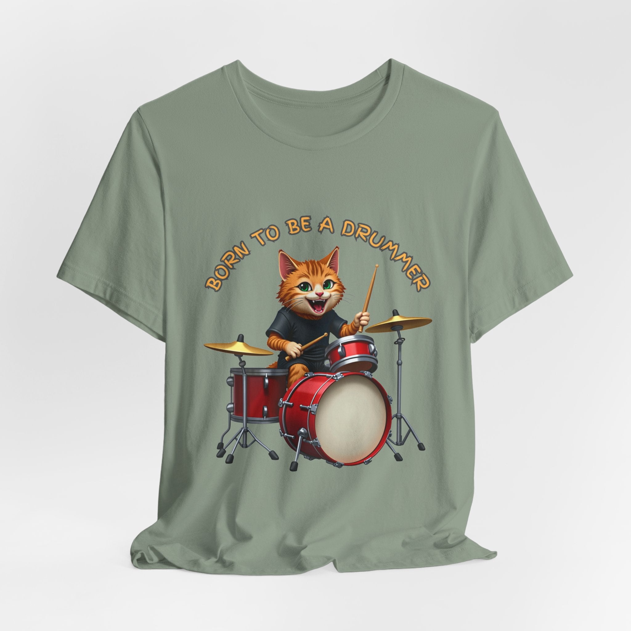 Sage green t-shirt with a cartoon cat playing drums and 'Born to be a Drummer' text on a white background