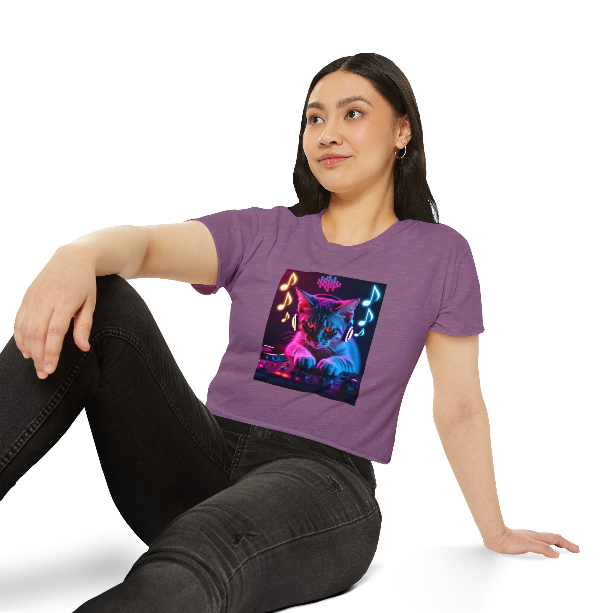 Person wearing a purple t-shirt with a colorful cat graphic and music notes.